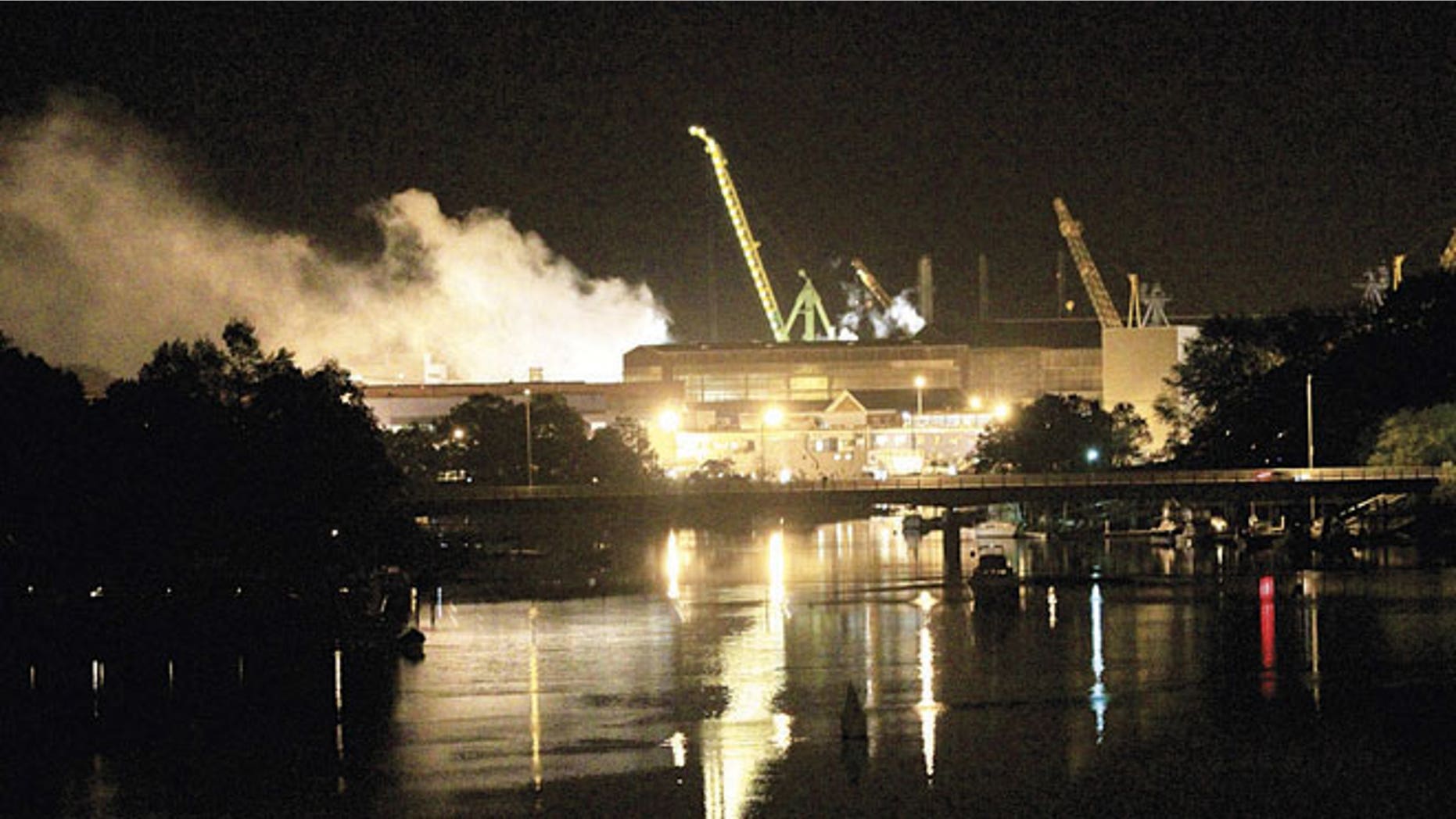 FILE: May 23, 2012: Smoke rises from a dry dock as fire crews respond to a fire on the USS Miami SSN 755 submarine at the Portsmouth Naval Shipyard on an island in Kittery, Maine.