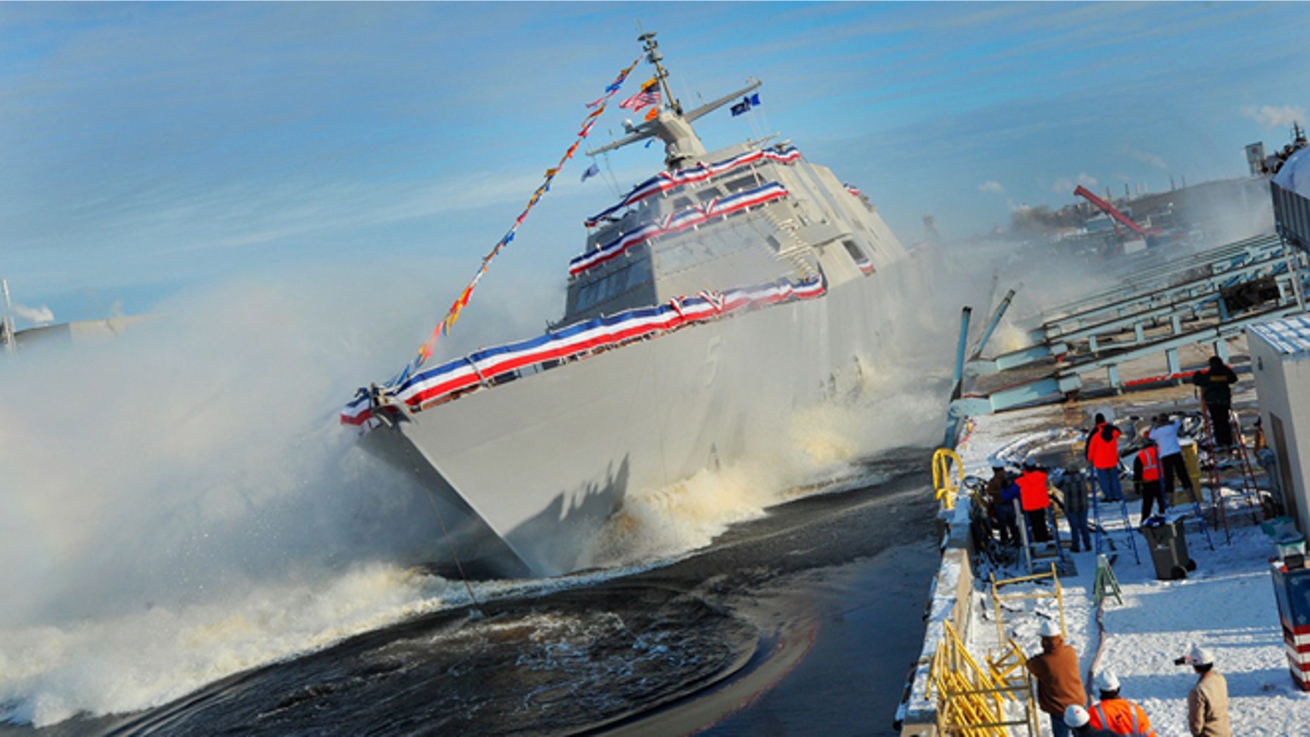 The littoral combat ship Pre-Commissioning Unit Milwaukee (LCS 5) slides into Lake Michigan during a christening ceremony at the Marinette Marine Corporation shipyard. (U.S. Navy photo courtesy of Lockheed Martin/Released)