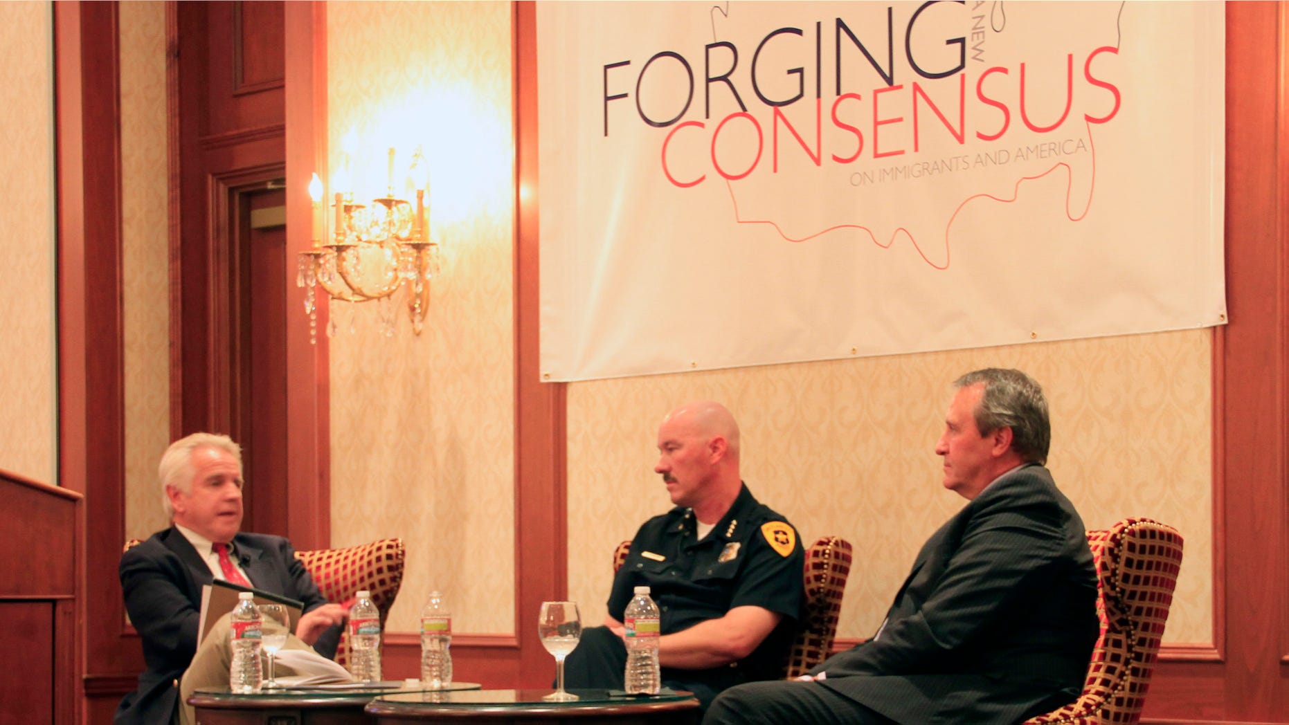 Doug Wright (left), a Utah radio show host, moderates a panel with Salt Lake City Police Chief Chris Burbank (middle), and Utah Attorney General Mark Shurtleff (right), as they discuss the effects that an enforcement-only immigration policy would have on police.
