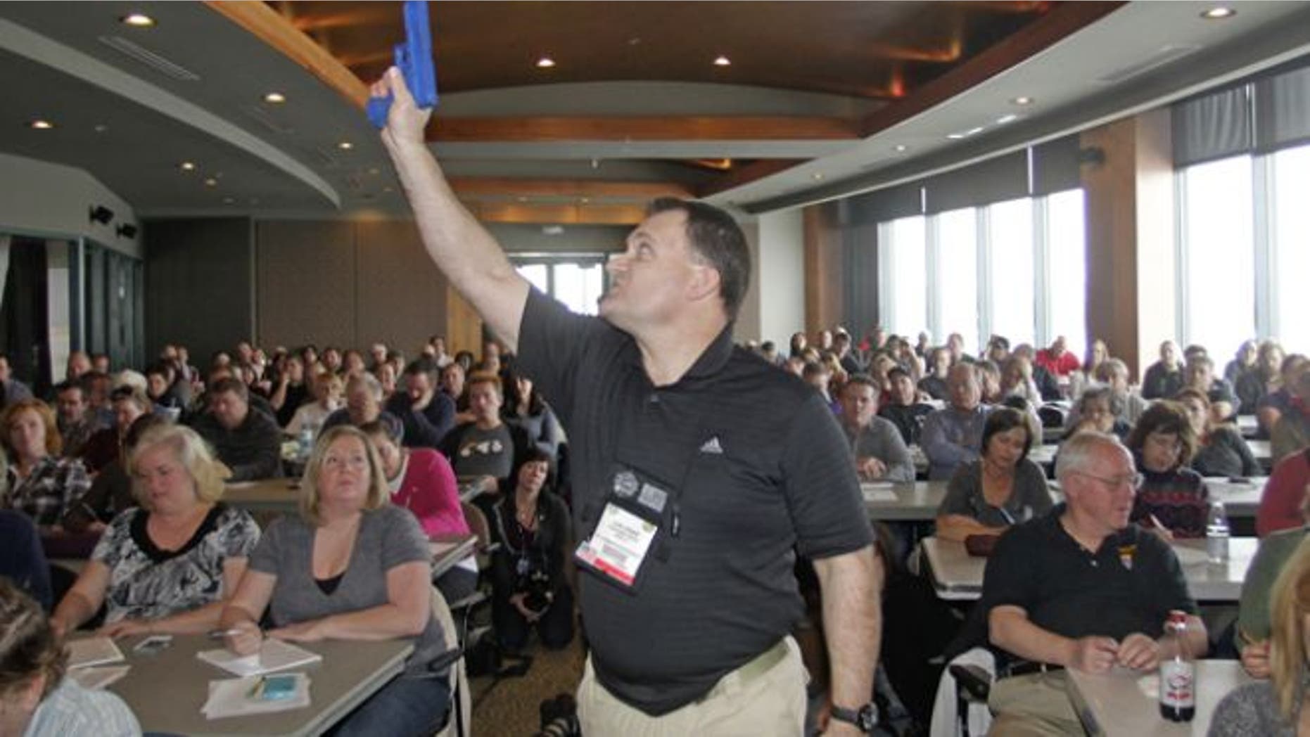 Dec. 27, 2012: Clark Aposhian, President of Utah Shooting Sport Council, demonstrates with a plastic gun during concealed-weapons training for 200 Utah teachers.