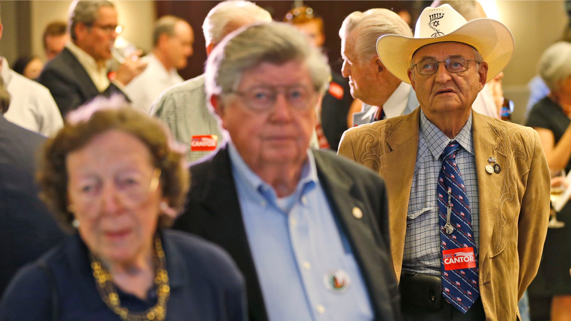 Supporters for House majority leader Congressman Eric Cantor, R-Va., watch election results at his election night party in Richmond, Va., Tuesday, June 10, 2014. Cantor was beaten in the GOP primary by tea party candidate Dave Brat. (AP Photo/Steve Helber)