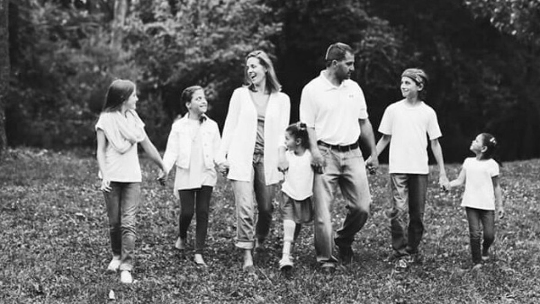 Kim Vaillancourt, center, and her husband Phil, right, had just adopted three girls and found out they were expecting when Kim was diagnosed with grade 4 glioblastoma.