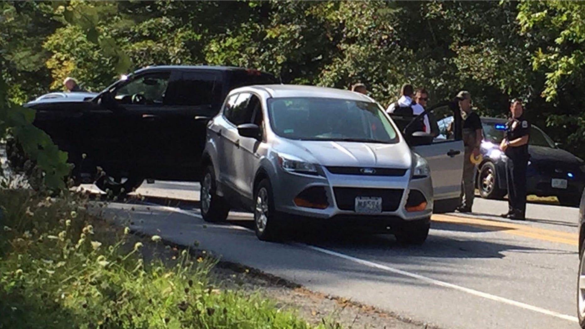 Police surround the suspect's vehicle near Dartmouth-Hitchcock Medical Center in Lebanon, N.H.