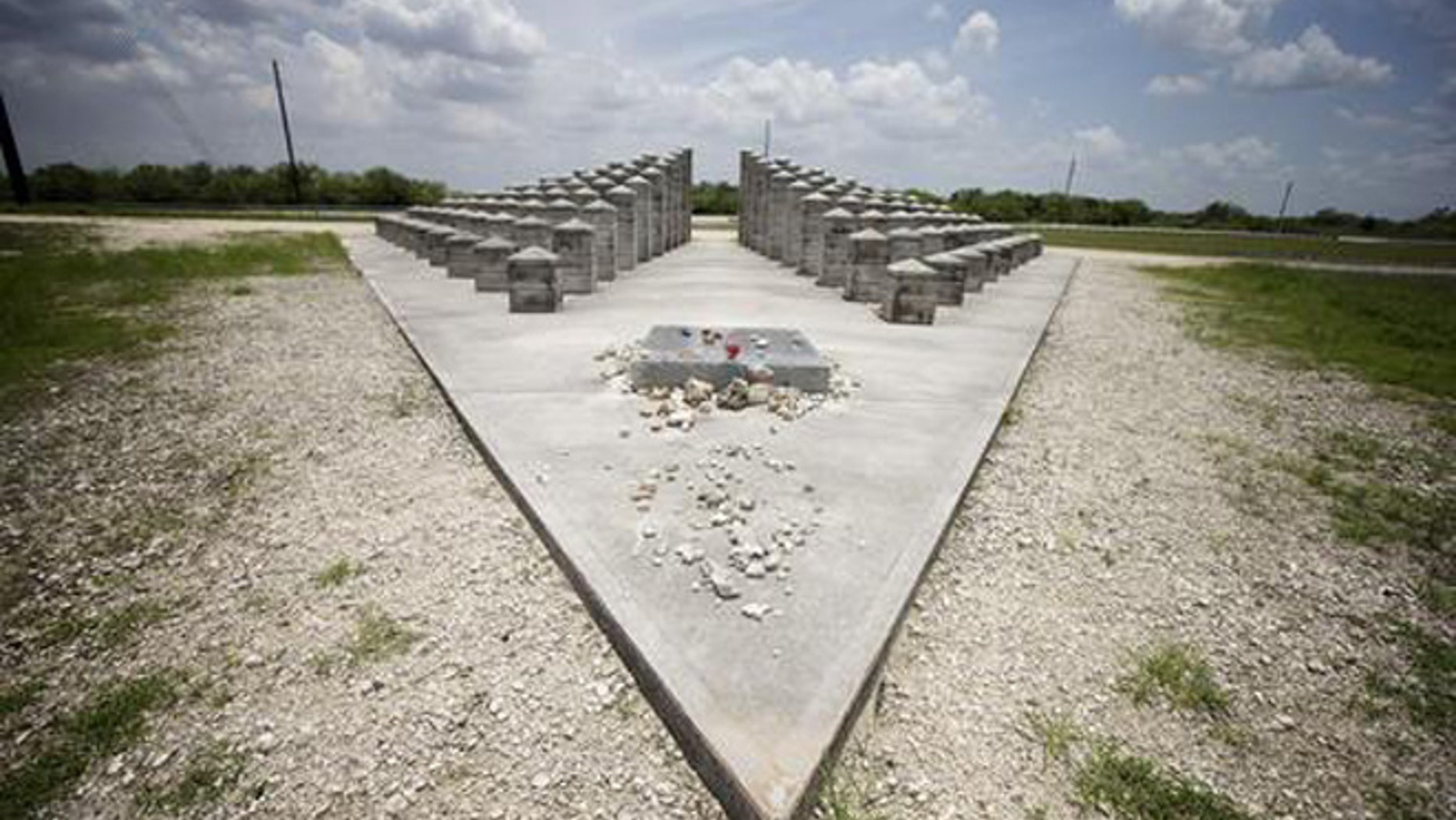HOLD FOR STORY BY JENNIFER KAY- In this June 25, 2014 file photo, the ValuJet Memorial is seen in the Florida Everglades in Everglades National Park. ValuJet Flight 592 crashed while trying to make an emergency return to Miami on May 11,1996, killing all 110 people on board. Relatives of the victims of Flight 592 will meet in the Florida Everglades to mark the 20th anniversary. (AP Photo/J. Pat Carter, File)
