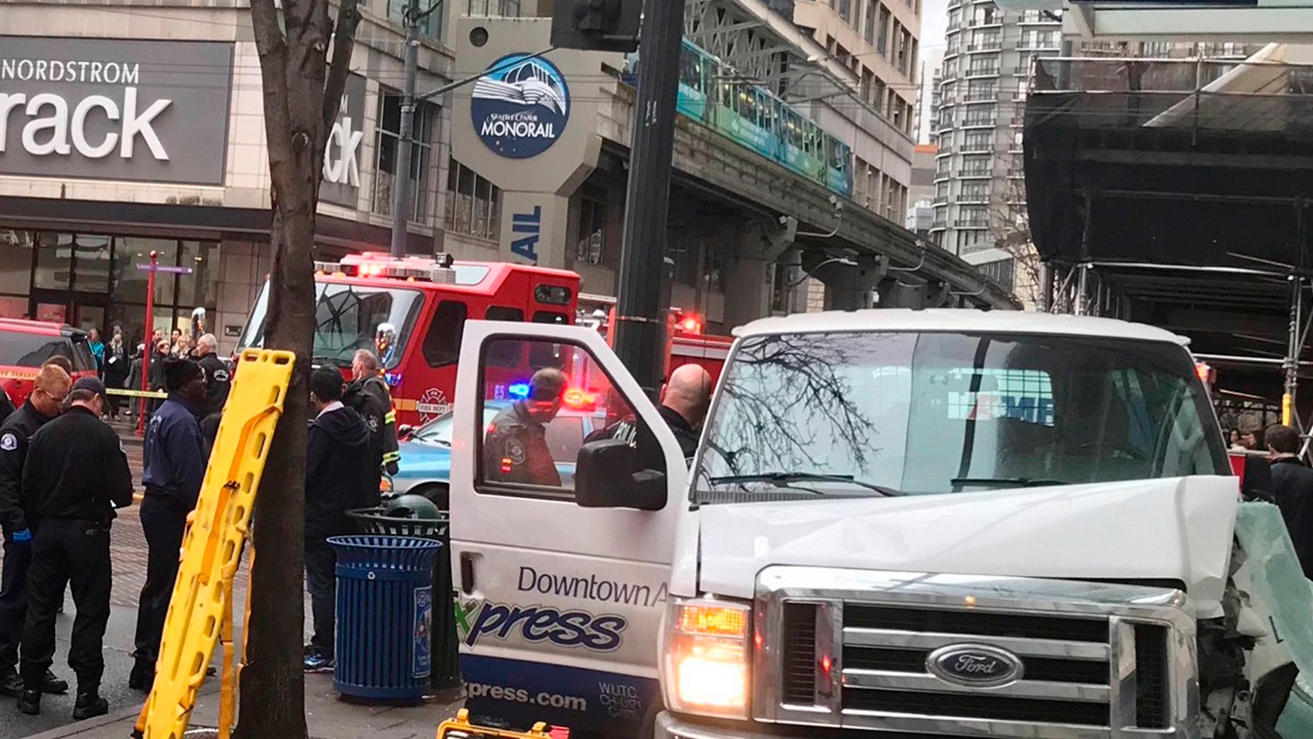The scene of a van crash in Seattle on Thursday, Dec. 28, 2017. Authorities say six people were sent to hospitals after the van left the street and hit a building.