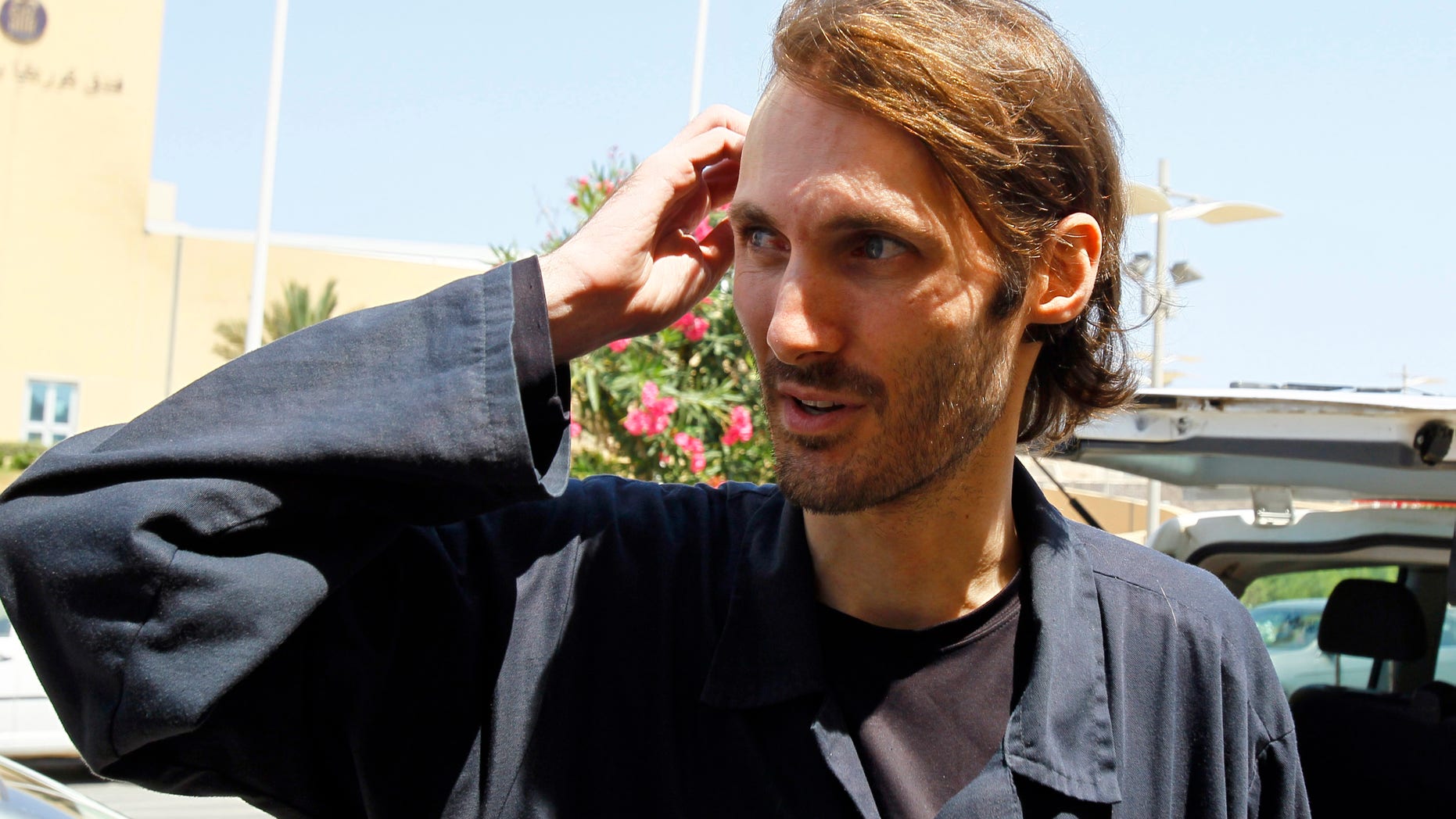 American writer and filmmaker Matthew VanDyke , from Baltimore, released from Abu Salim prison after spending 6 months imprisoned, is seen in front of the Corinthia Hotel in Tripoli, Libya, Saturday, Aug. 27, 2011.