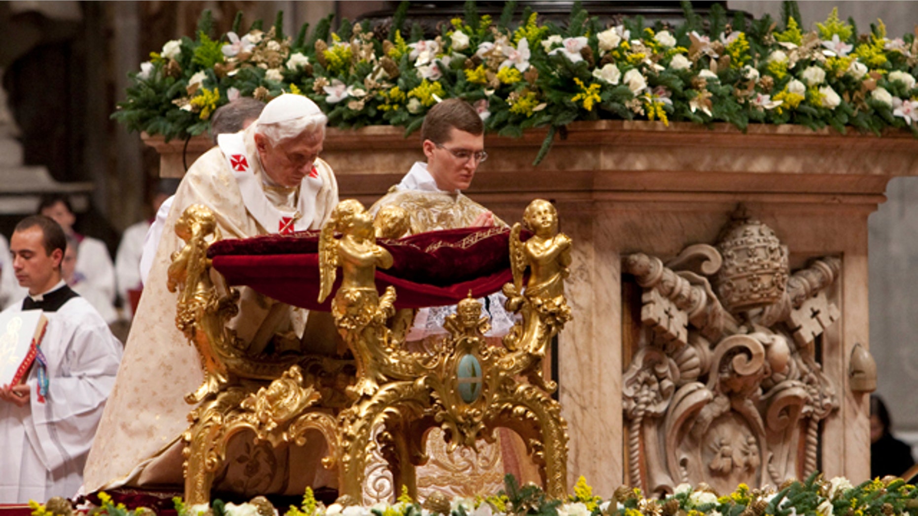 Dec. 24, 2011: Pope Benedict XVI kneels in prayer as he celebrates Christmas Mass in St. Peter's Basilica at the Vatican.