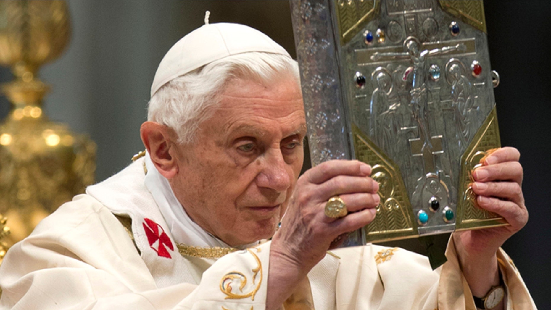 Nov. 25, 2012: Pope Benedict XVI holds the holy Gospel as he celebrates a mass for the newly elected cardinals in St. Peter's Basilica at the Vatican. )