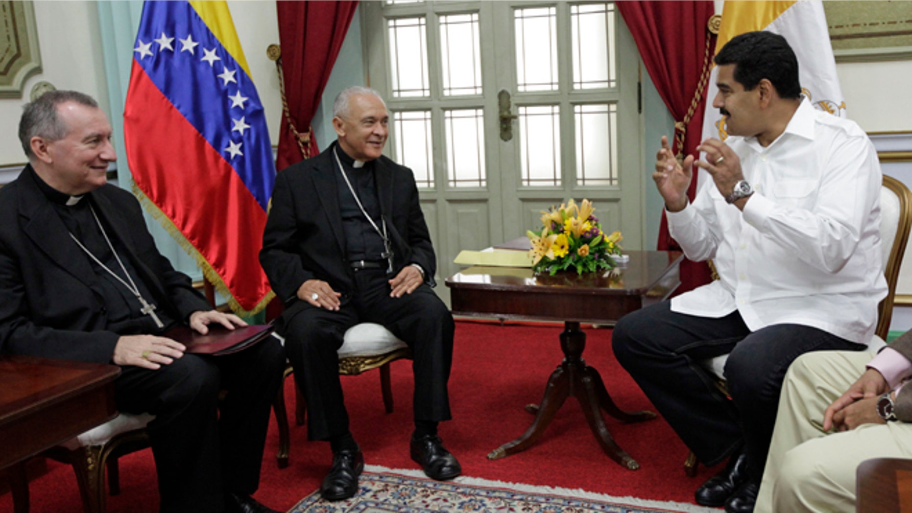 June 14, 2013: In thisphoto, Venezuela's President Nicolas Maduro, right, meets with Venezuela's Archbishop Diego Rafael Padron Sanchez, left and Italian Pietro Parolin, Holy See's representative in Venezuela, at Miraflores presidential palace in Caracas, Venezuela.