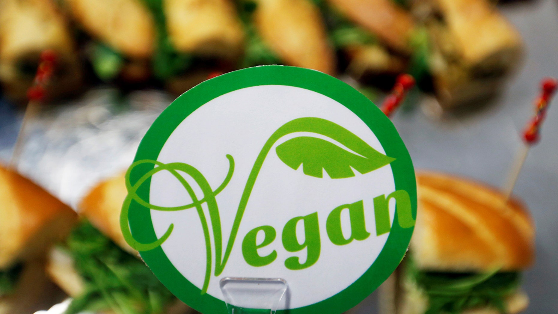 File 2017: A sticker with the word vegan is seen near sandwiches in Toulouse, France. A British chef is receiving backlash after claiming to have put additional non-essential ingredients to a vegan diner's dish on Saturday night.