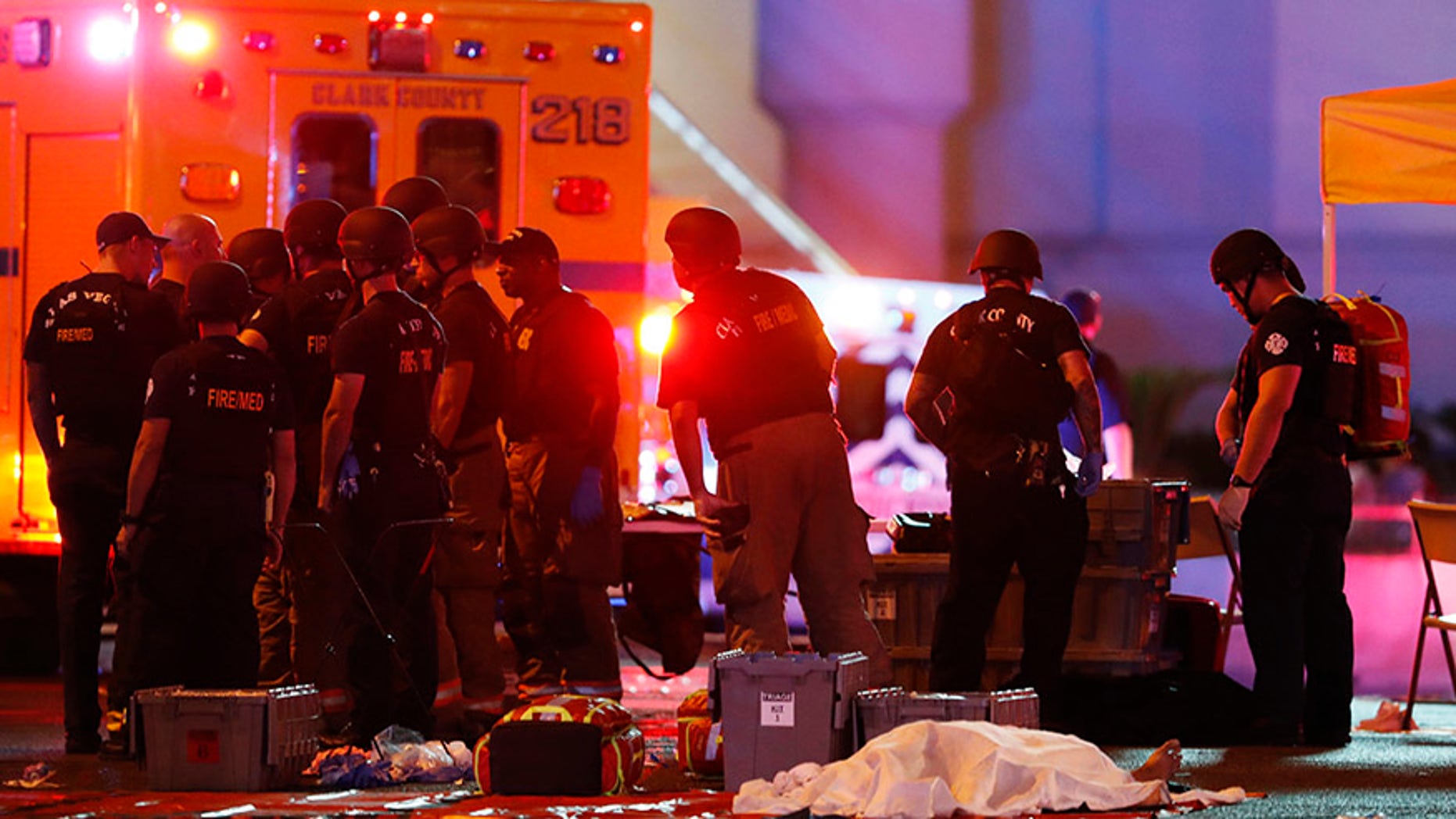 A body is covered with a sheet after the Las Vegas shooting. Victims of the attack say conspiracy theorists are flooding their social media pages.