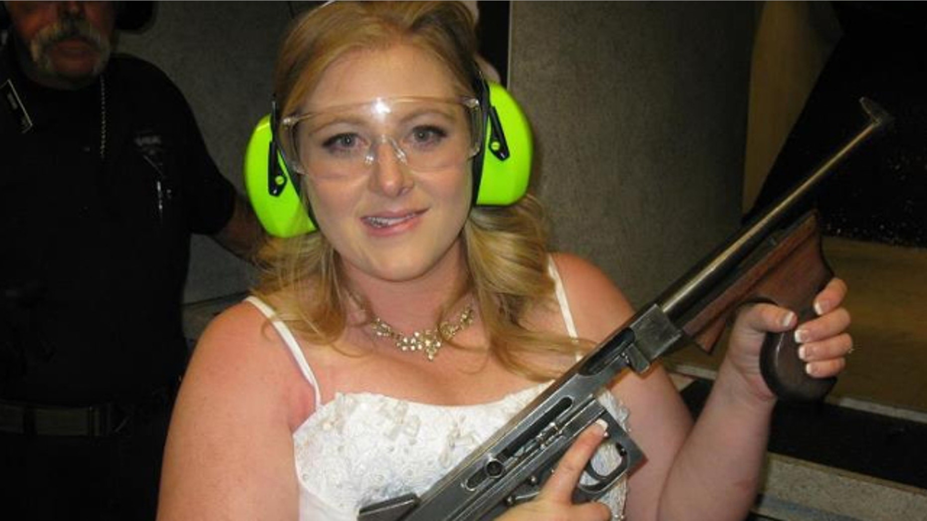 July 28, 2012: Lindsae MacDuff holds an automatic weapon at the Gun store in Las Vegas after her "shotgun wedding."