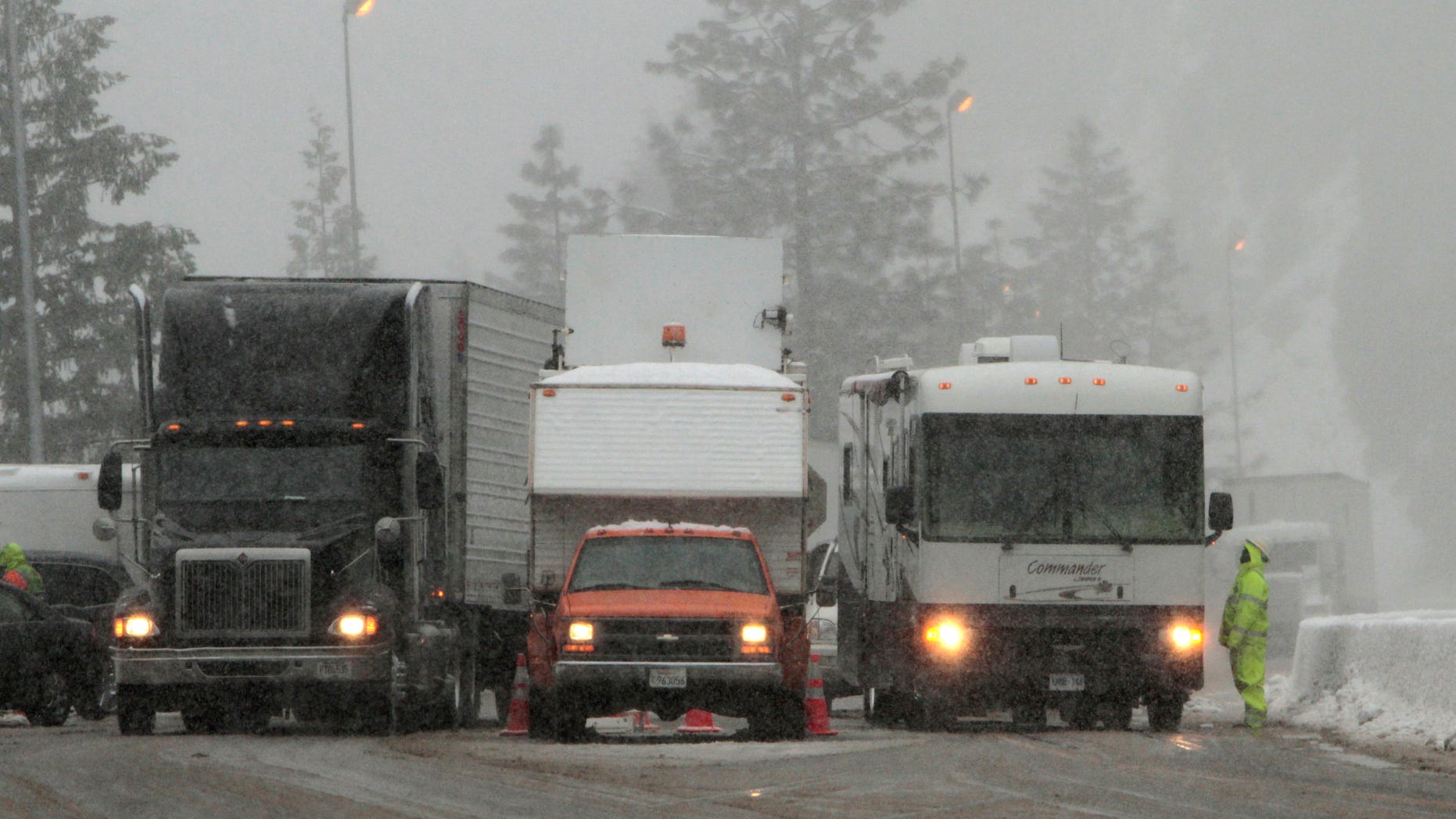 Vehicles pass through a California Departement of Transportation chain inspection stop on eastbound Interstate 80 near Alta, Calif., Thursday March 24, 2011. (AP)