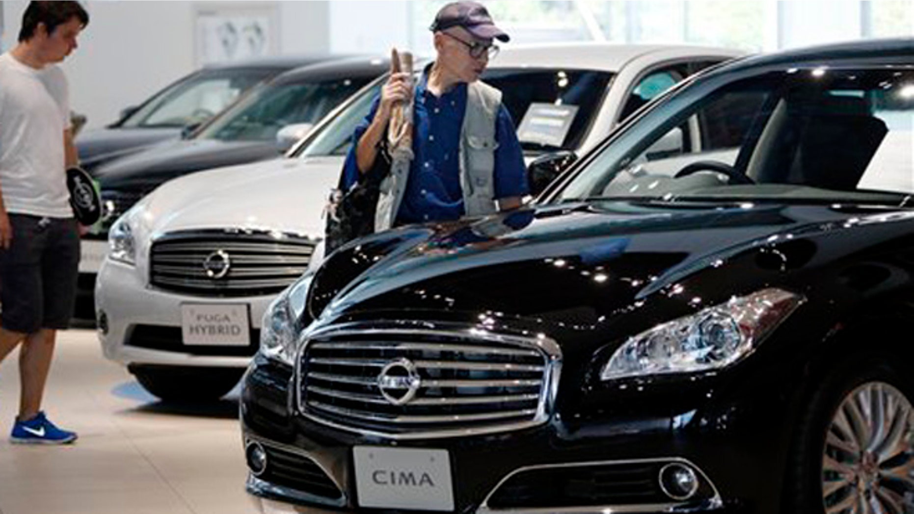 FILE: July 26, 2012: Visitors inspect cars at the Nissan Motor Co. global headquarters in Yokohama, Japan.