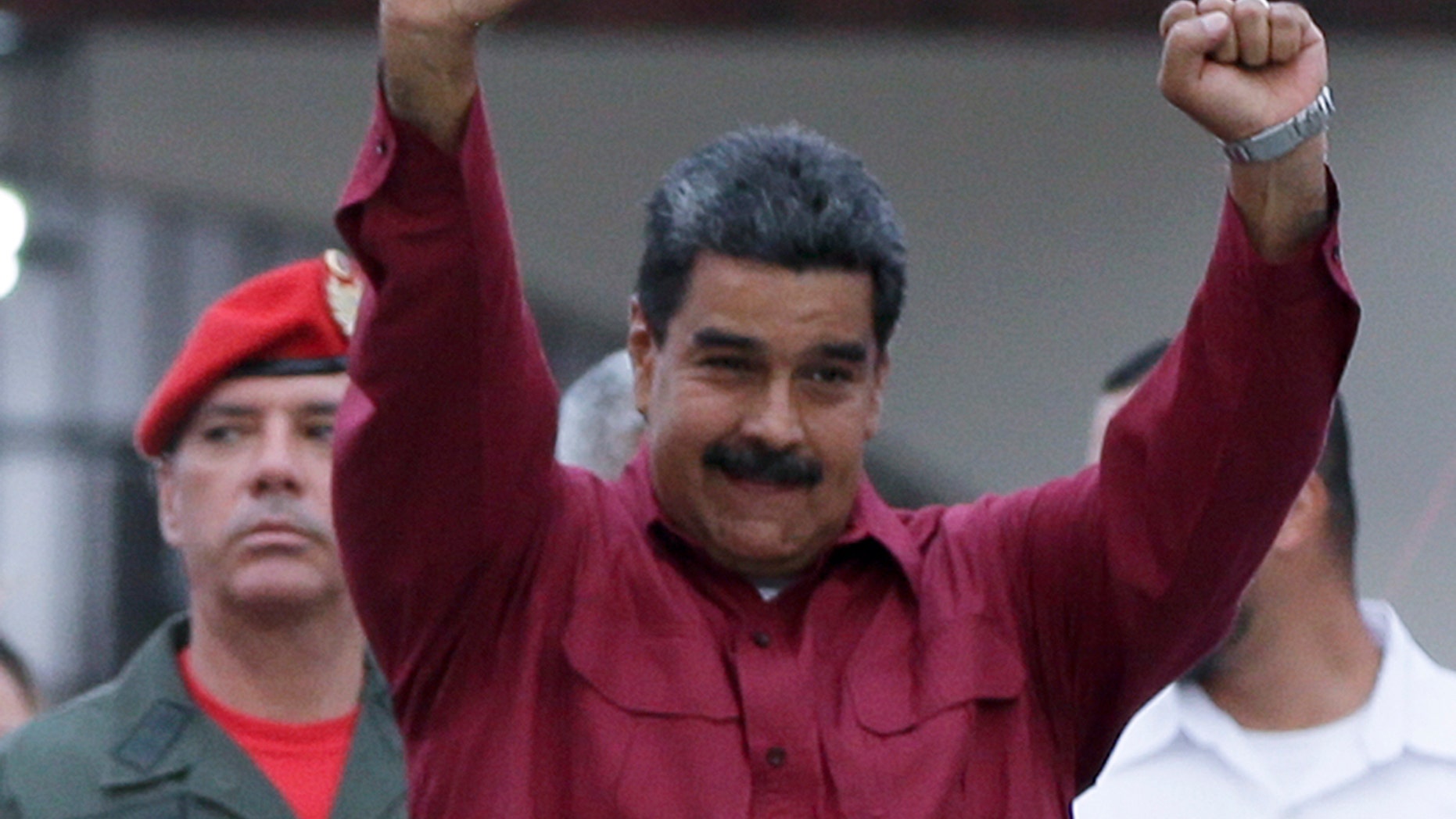 Venezuela's President Nicolas Maduro raises his fists after voting in presidential elections in Caracas, Venezuela, Sunday, May 20, 2018.
