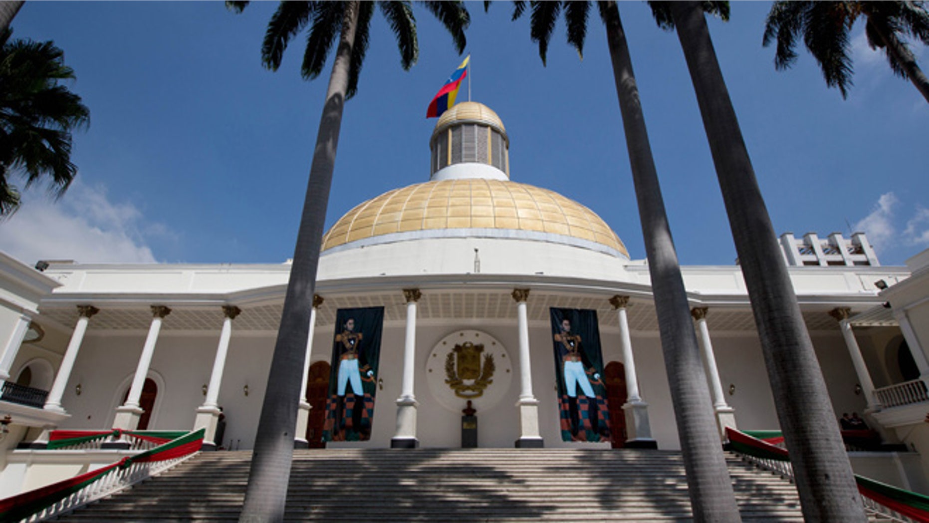 Paintings of Venezuelan independence hero Simon Bolivar decorate the stairs of the National Assembly building in Caracas, Venezuela, Monday, Jan. 11, 2016. Venezuela's Supreme Court has ordered the country's new opposition congress to unseat three barred lawmakers and is declaring that any action the body takes in the meantime is null. The court published a decision Monday that said the congress' acts would be void while the three lawmakers were seated. (AP Photo/Fernando Llano)