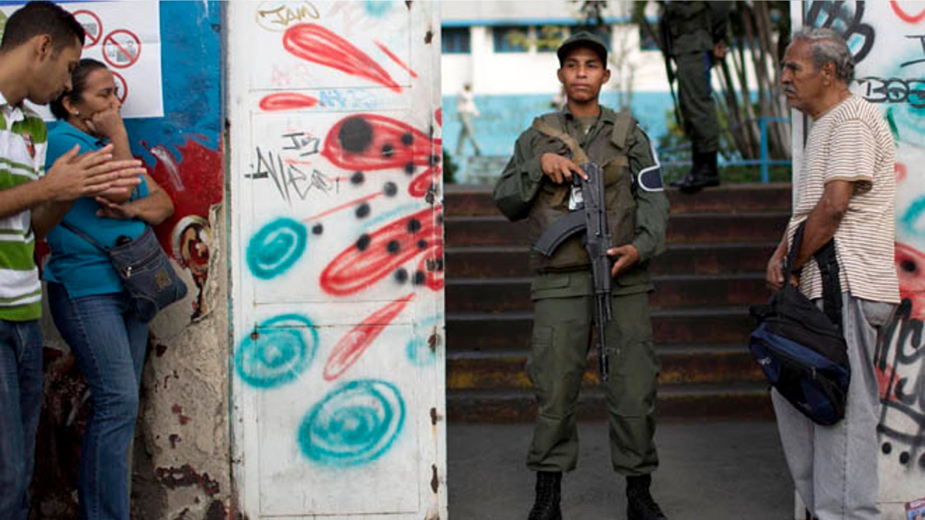 Dec. 6, 2015: A National Guard soldier stand guard at the entrance of a polling station during congressional elections in Caracas, Venezuela.