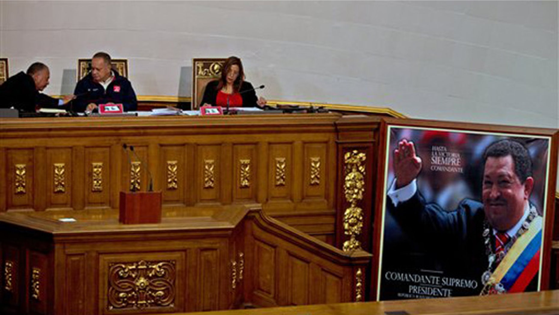 President of National Assembly, Diosdado Cabello, center, speaks with the first Vice President Elvis Amoroso, left, next to the second Vice President Tania Diaz, during a session in Caracas, Venezuela, Thursday, Dec. 10, 2015. Venezuela's ruling socialist party is set to rush through a series of appointments before the opposition takes over congress next month with promises to revive what it calls a moribund institution. The legislature was expected to name 12 Supreme Court justices Thursday during a final session, filling vacancies left by a group of judges who requested early retirement. (AP Photo/Fernando Llano)