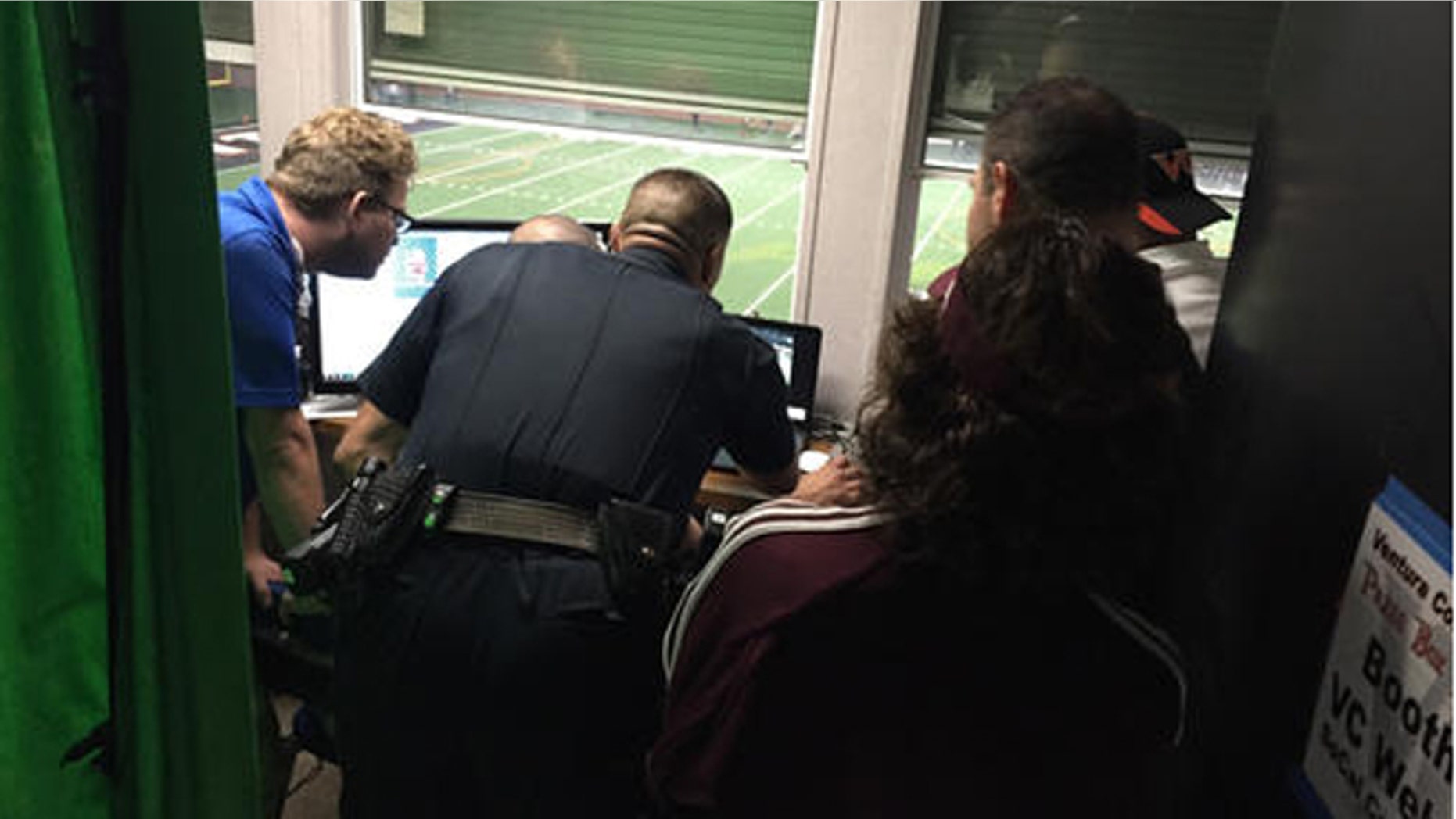 Ventura College police officer reviews game footage to determine whether a Mt. St. Antonio College football player punched a referee during a game Saturday. (Joe Curley/The Ventura County Star via AP)