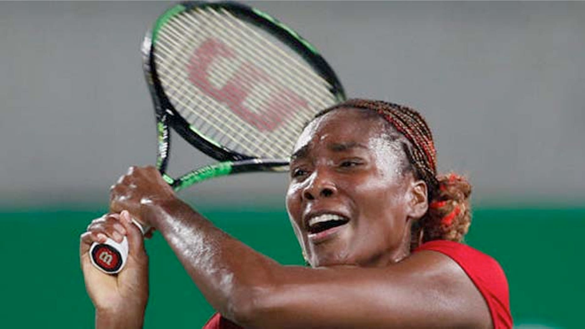 Venus Williams returns a ball in the women's tennis competition at the 2016 Summer Olympics Saturday.
