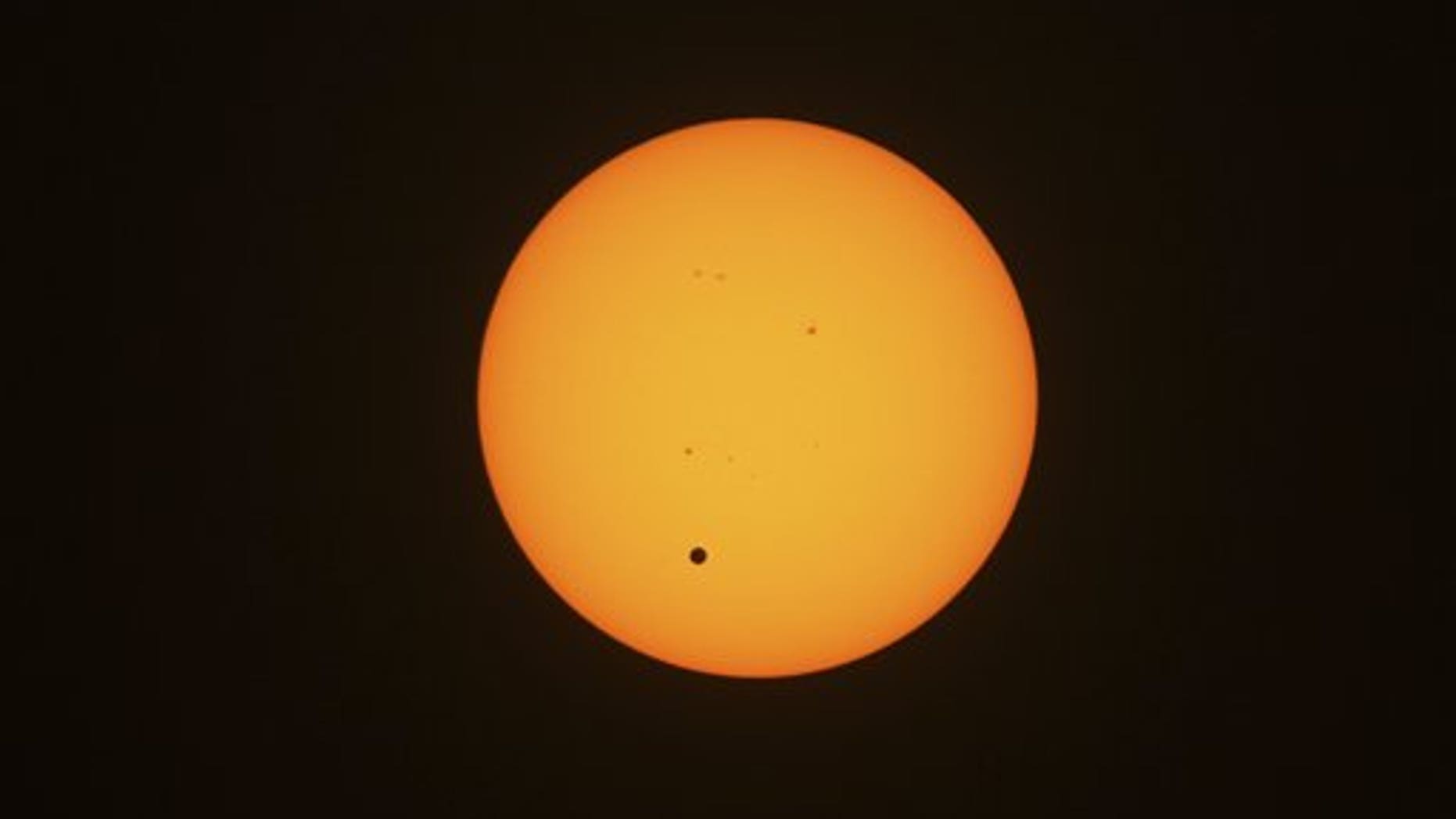 June 6, 2012: This photo taken through viewing glasses shows Venus crossing the sun in Sydney, Australia.