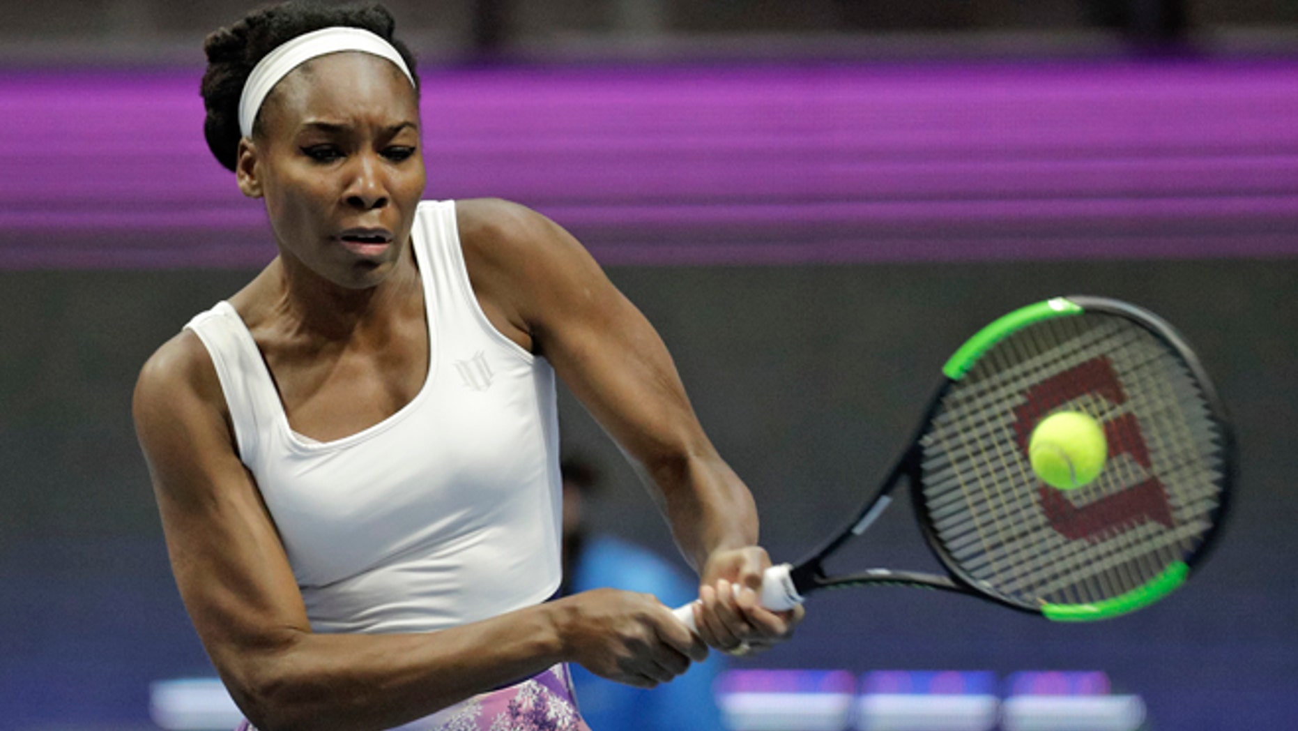 Venus Williams of the U.S. returns the ball to Kristina Mladenovic of France during the St. Petersburg Ladies Trophy-2017 tennis tournament match in St. Petersburg, Russia, Thursday, Feb. 2, 2017. (AP Photo/Dmitri Lovetsky)