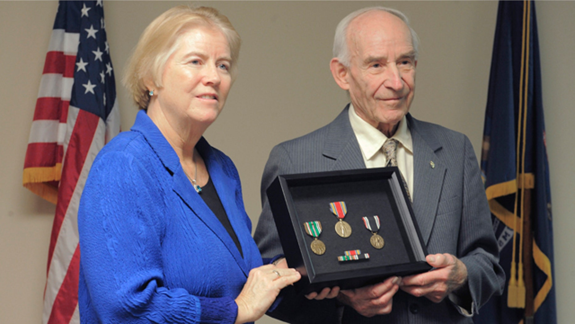Dec. 7, 2012: Rep. Candice Miller presents William Pollauf with several medals, Friday Dec. 7, 2012, at her office in Shelby Twp., Mich.