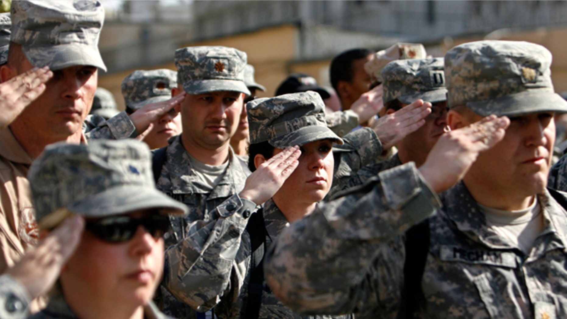 FILE: Nov. 11, 2008: US soldiers of Combined Security Transition Command salute during a Veterans Day ceremony in Kabul, Afghanistan.