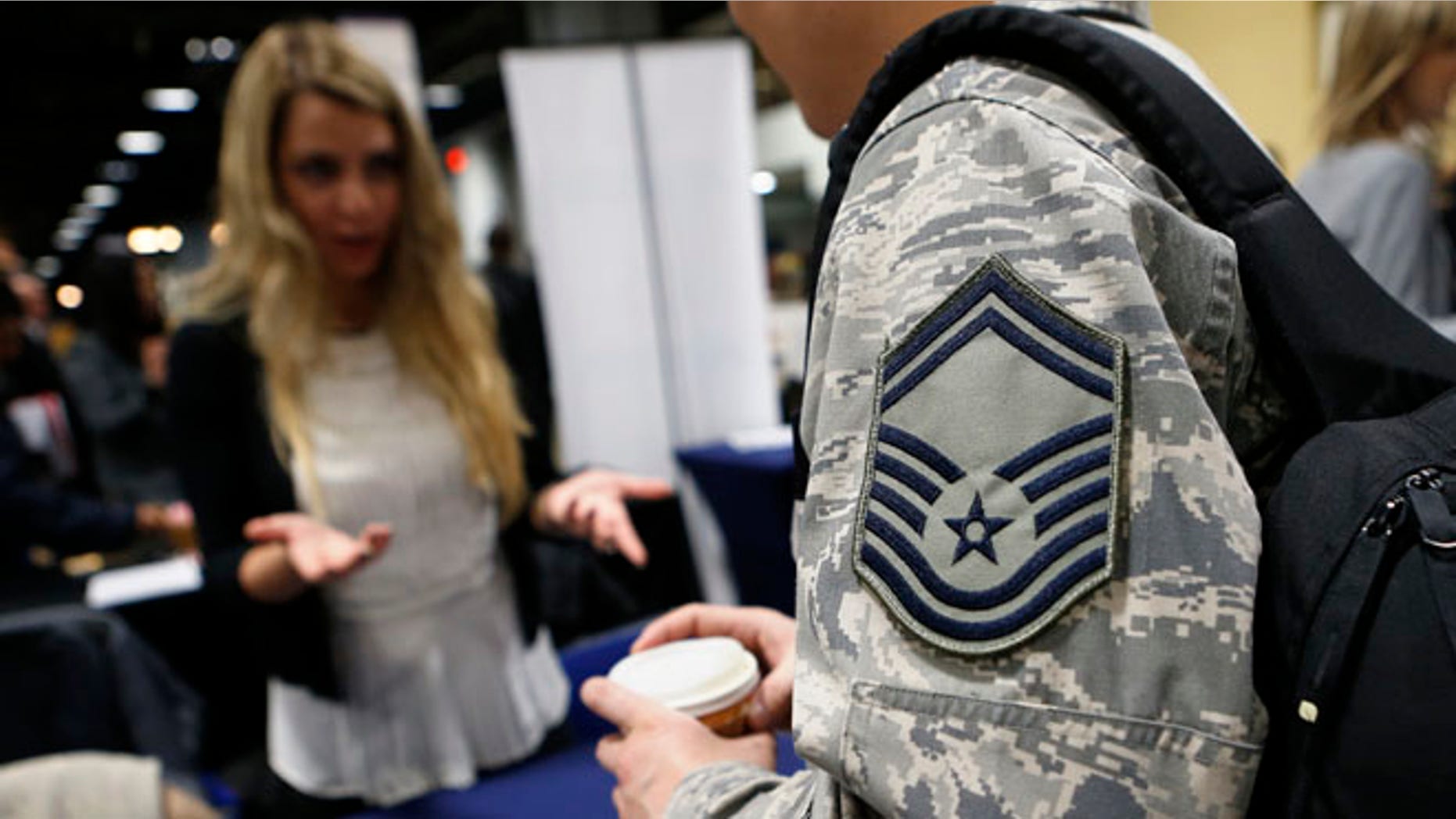 FILE: January 10, 2014: An Air Force sergeant talks with a recruiter at the Hiring Our Heroes job fair in Washington, D.C.