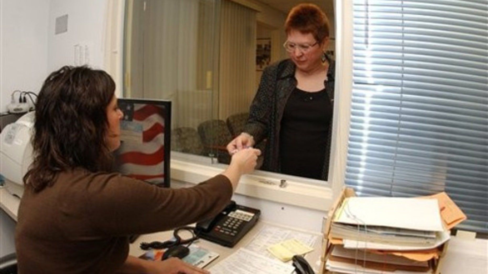 U.S. Air Force veteran Wendy Haylor, of Piedmont, W.Va., checks in with Amy Theriault, Women Veterans Program Manager at the Women Veterans Health Clinic Friday, Nov. 13, 2009, at the Veterans Affairs Medical Center in Martinsburg, W. Va. (AP Photo/Ron Agnir)