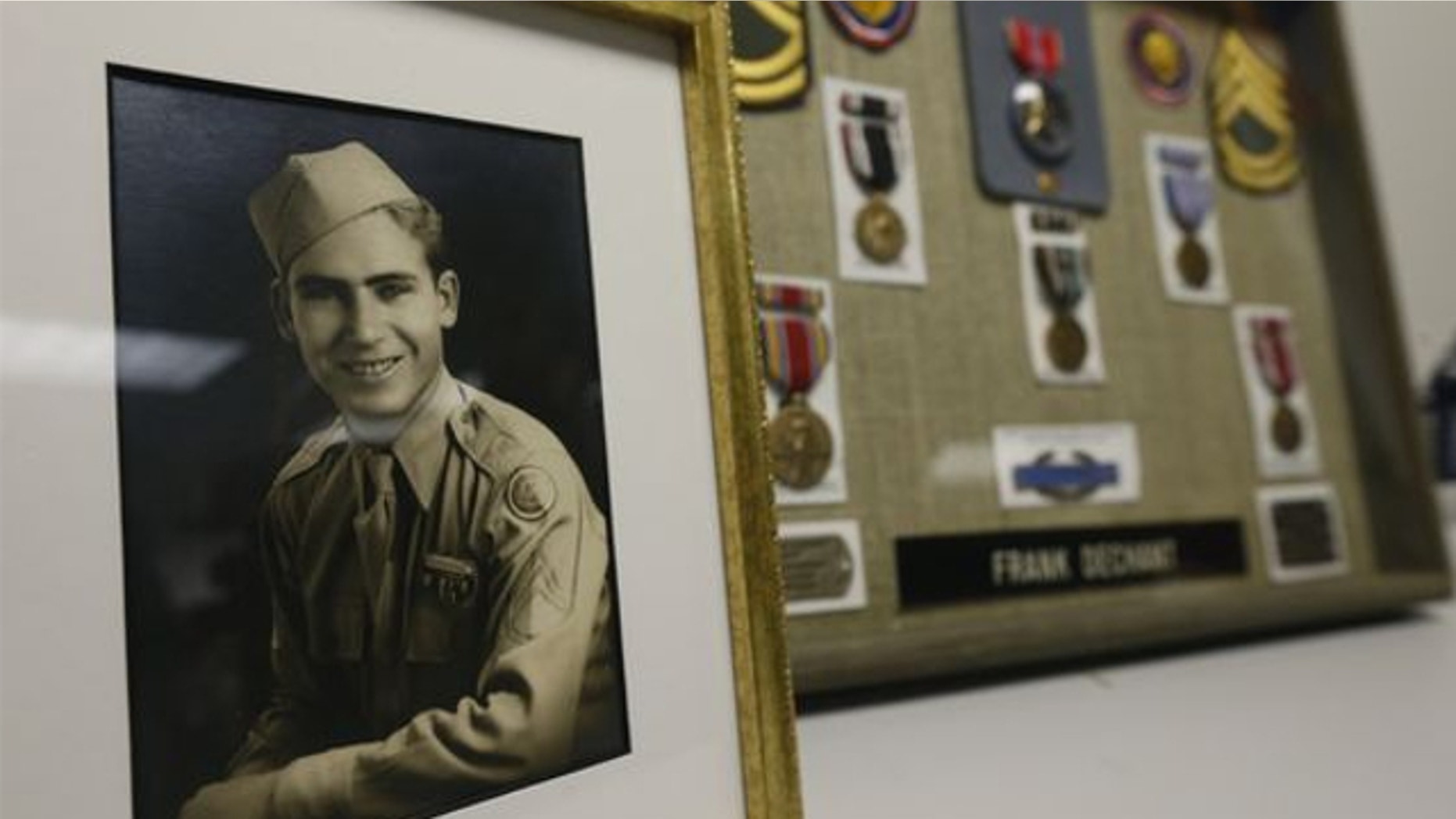 April 14, 2014: A framed photo and medals, including a Bronze Star, sit on display during a ceremony at which 91-year-old World War II veteran Frank Dechant received the United States Prisoner of War Medal, in Lakewood, Colo.