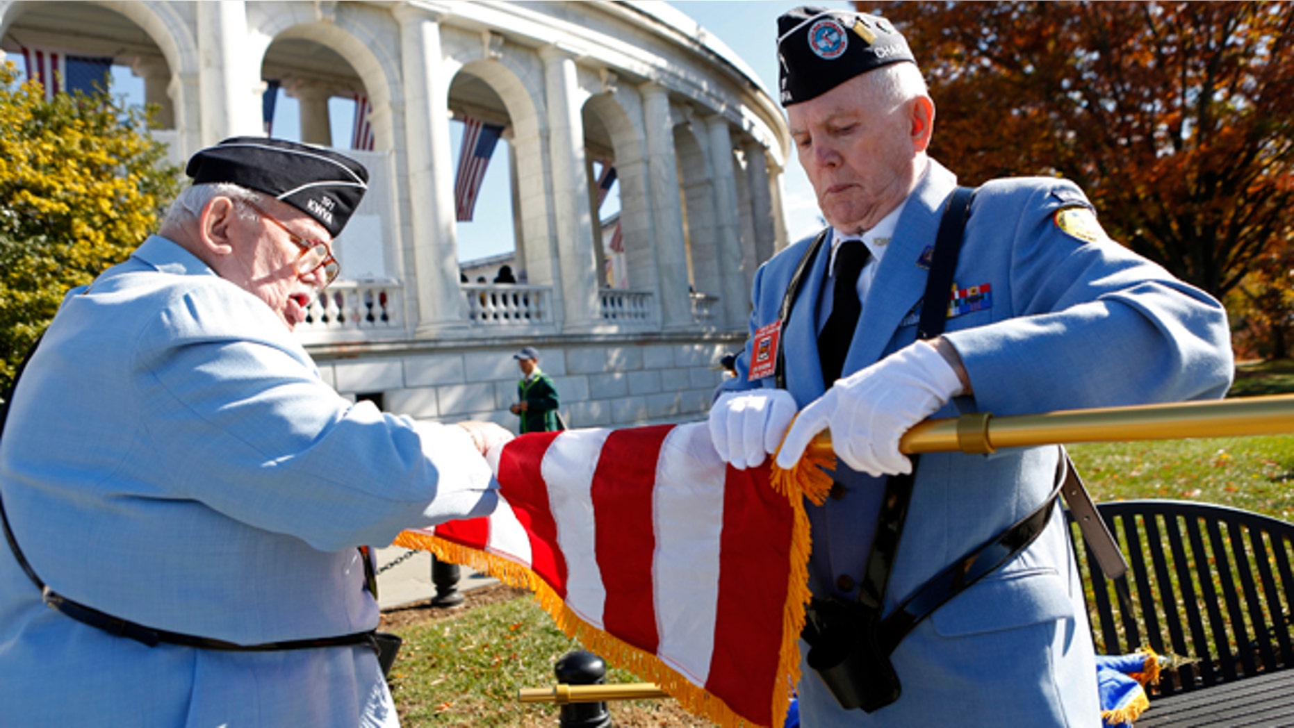 Nov. 11, 2013: Members of a veterans' honor guard furl a flag after a ceremony at Arlington National Cemetery on Veterans Day in Washington.