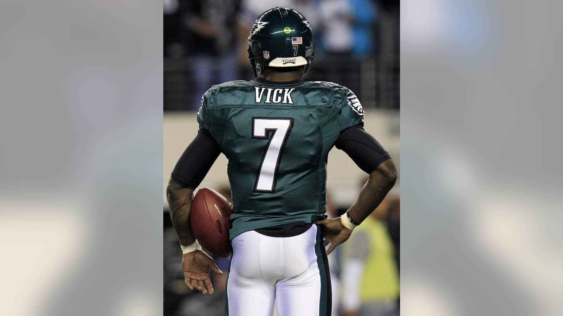 FILE - In this file photo taken Dec. 12, 2010, Philadelphia Eagles quarterback Michael Vick before playing the Dallas Cowboys at Cowboys Stadium in Arlington. (AP Photo/LM Otero, File)