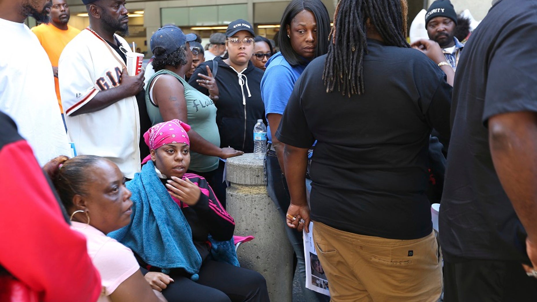 Lahtifa Wilson, 26, stabbing victim touches her wound outside of a MacArthur BART station a day after her sister was killed in an attack.