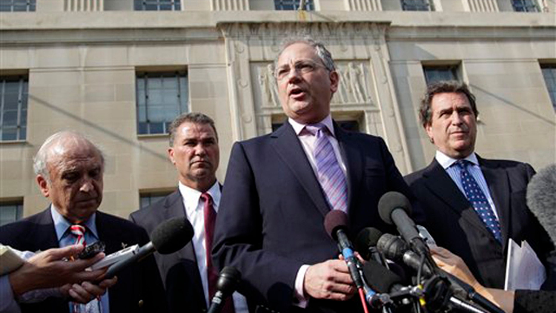 Relatives of victims of the Sept. 11 attacks in New York speak with reporters outside the Justice Department in Washington after a meeting with Attorney General Eric Holder Aug. 24.