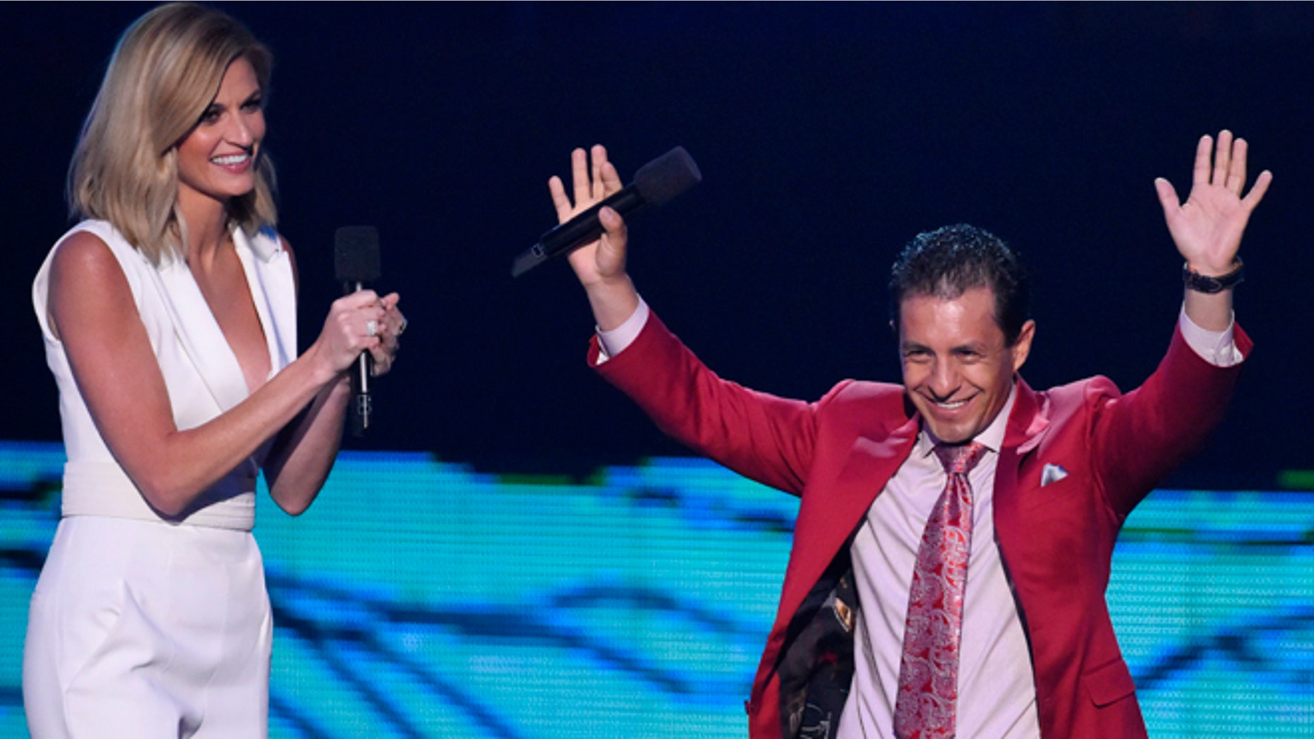 Triple Crown winning jockey Victor Espinoza, who rode American Pharoah, is introduced by show co-host Erin Andrews during the 2015 CMT Awards in Nashville, Tennessee June 10, 2015. REUTERS/Harrison McClary - RTX1G0BV