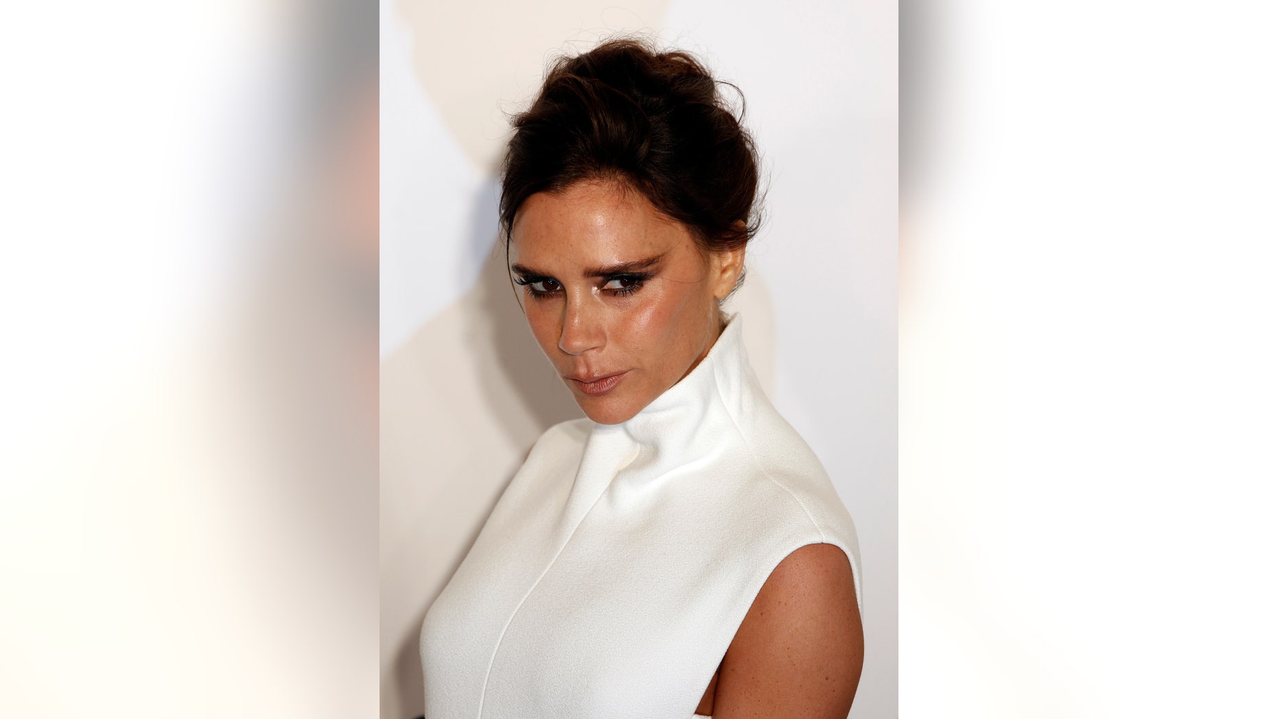 March 14, 2015. British fashion designer Victoria Beckham poses upon arrival at the Foundation for AIDS Research's (amfAR) inaugural fundraising gala in Hong Kong.