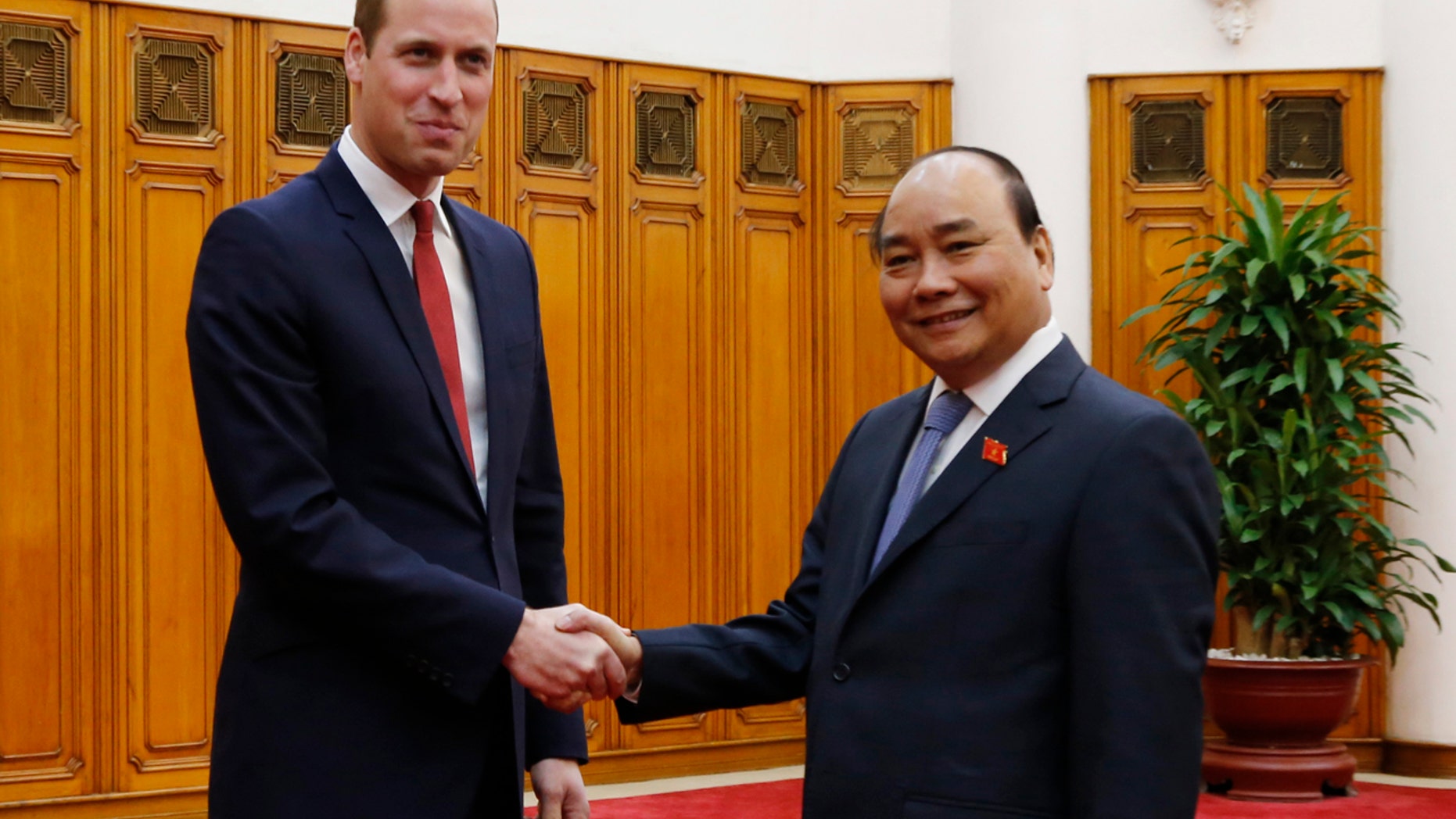 Britain's Prince William, left, shakes hands with Vietnamese Prime Minister Nguyen Xuan Phuc in Hanoi, Vietnam, Wednesday, Nov. 16, 2016.
