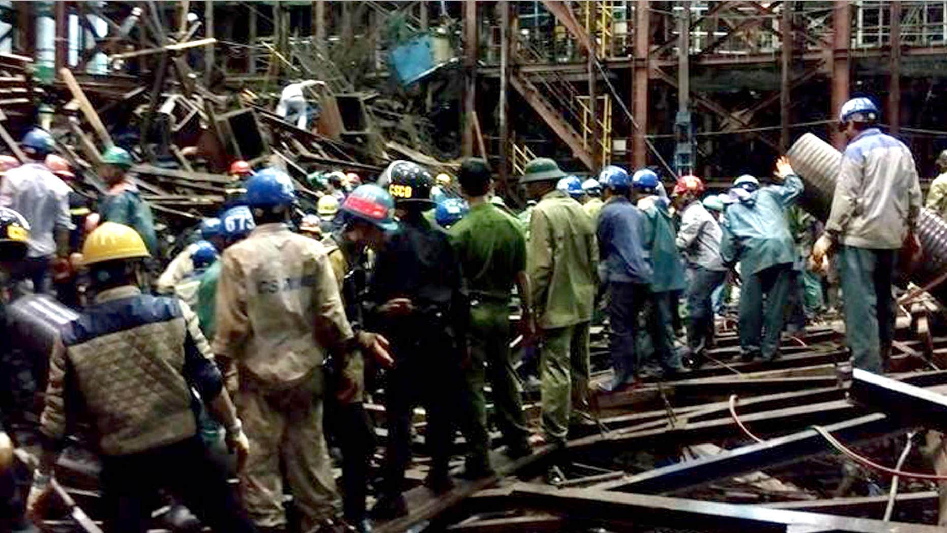 March 25, 2015: Rescuers work through the rubble trying to find survivors after scaffolding collapsed in an economic zone in Ha Tinh province in central Vietnam.