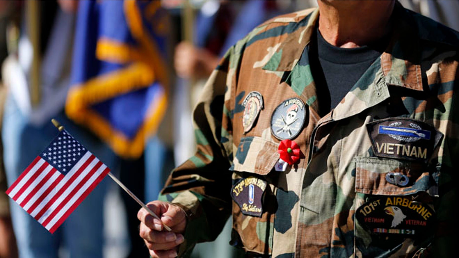 Nov. 11, 2013: A Vietnam veteran holds an American flag as he marches during the annual Veterans Day Parade in San Diego, Calif.