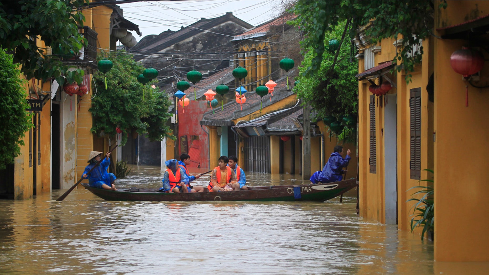People ride a boat in flooded street in Hoi An, Vietnam, Monday, Nov. 6, 2017.