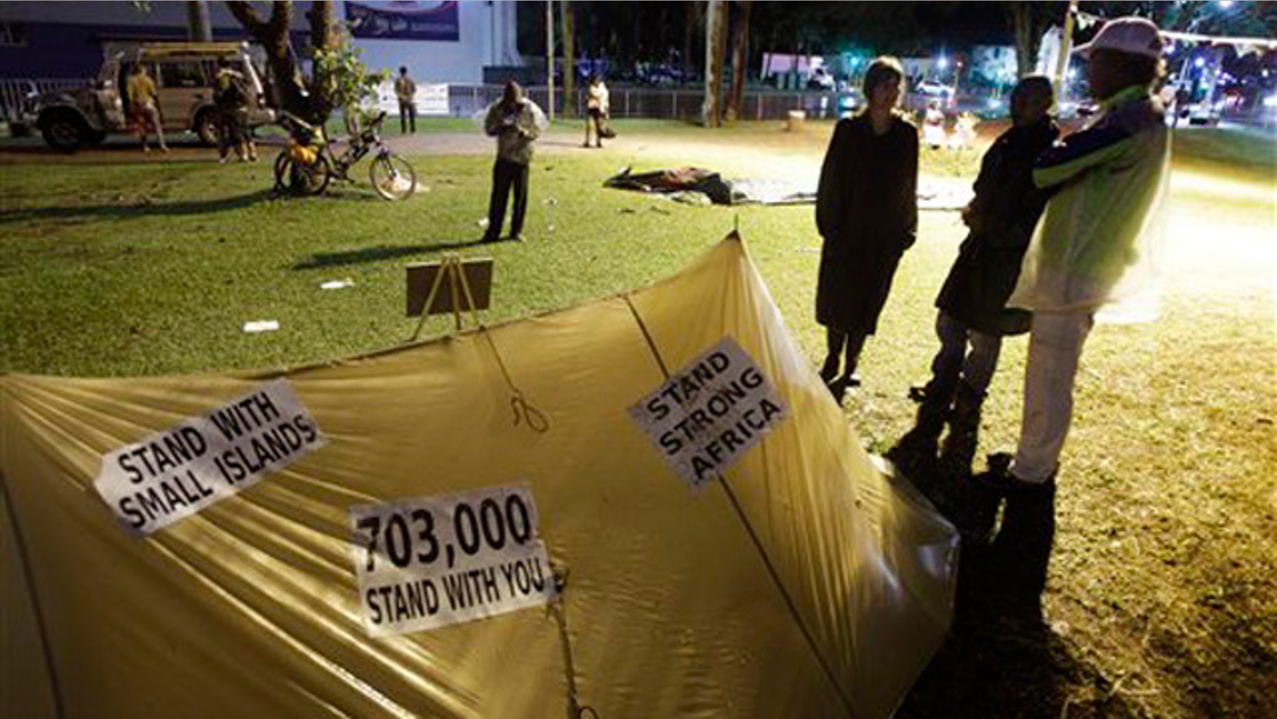 Dec. 9, 2011: Protesters hold a night vigil as talks at the climate change summit stall in Durban, South Africa.