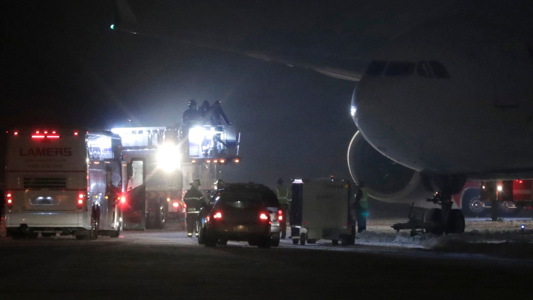 Players, coaches and staff from the Minnesota Vikings are taken off a plane in small groups at Appleton International Airport on Friday, Dec. 23, 2016, in Appleton, Wis.