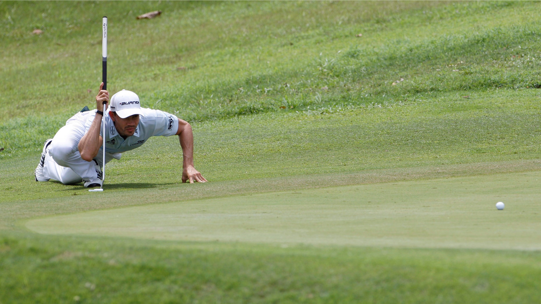 Camilo Villegas of Colombia lines up his putt on the 8th green during the third round of the Asia Pacific Classic Malaysia golf tournament at The Mines Resort & Golf Club in Kuala Lumpur, Malaysia, Saturday, Oct. 29, 2011. (AP Photo/Lai Seng Sin)