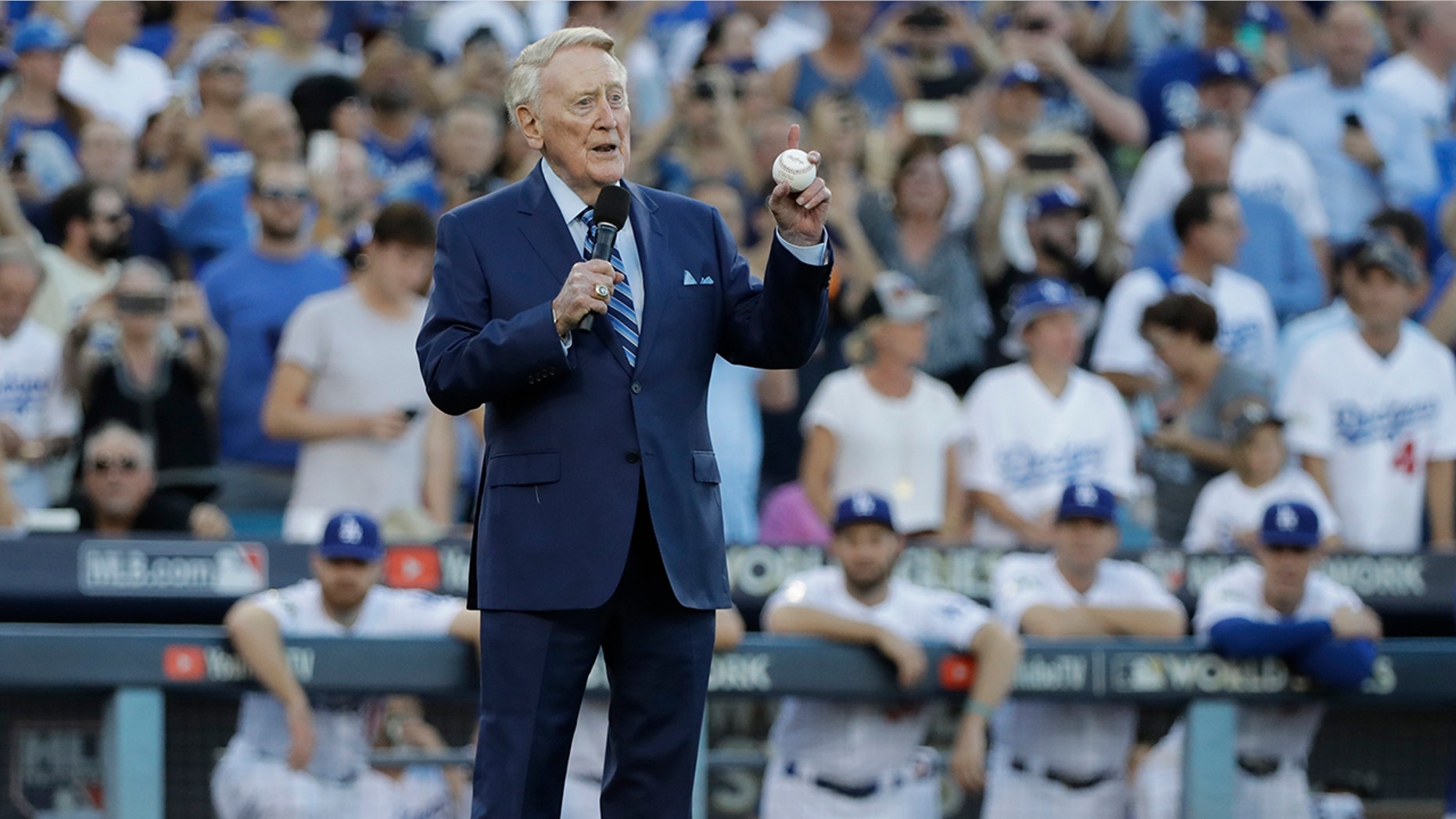 Vin Scully helps throw out the ceremonial first pitch before Game 2 of baseball's World Series between the Houston Astros and the Los Angeles Dodgers Wednesday, Oct. 25, 2017, in Los Angeles.