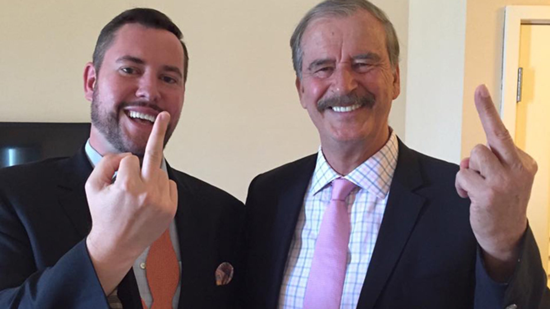 Former Mexican President Vicente Fox (right) makes an obscene gesture to Donald Trump after appearing on the Kickass Politics podcast with host Ben Mathis.