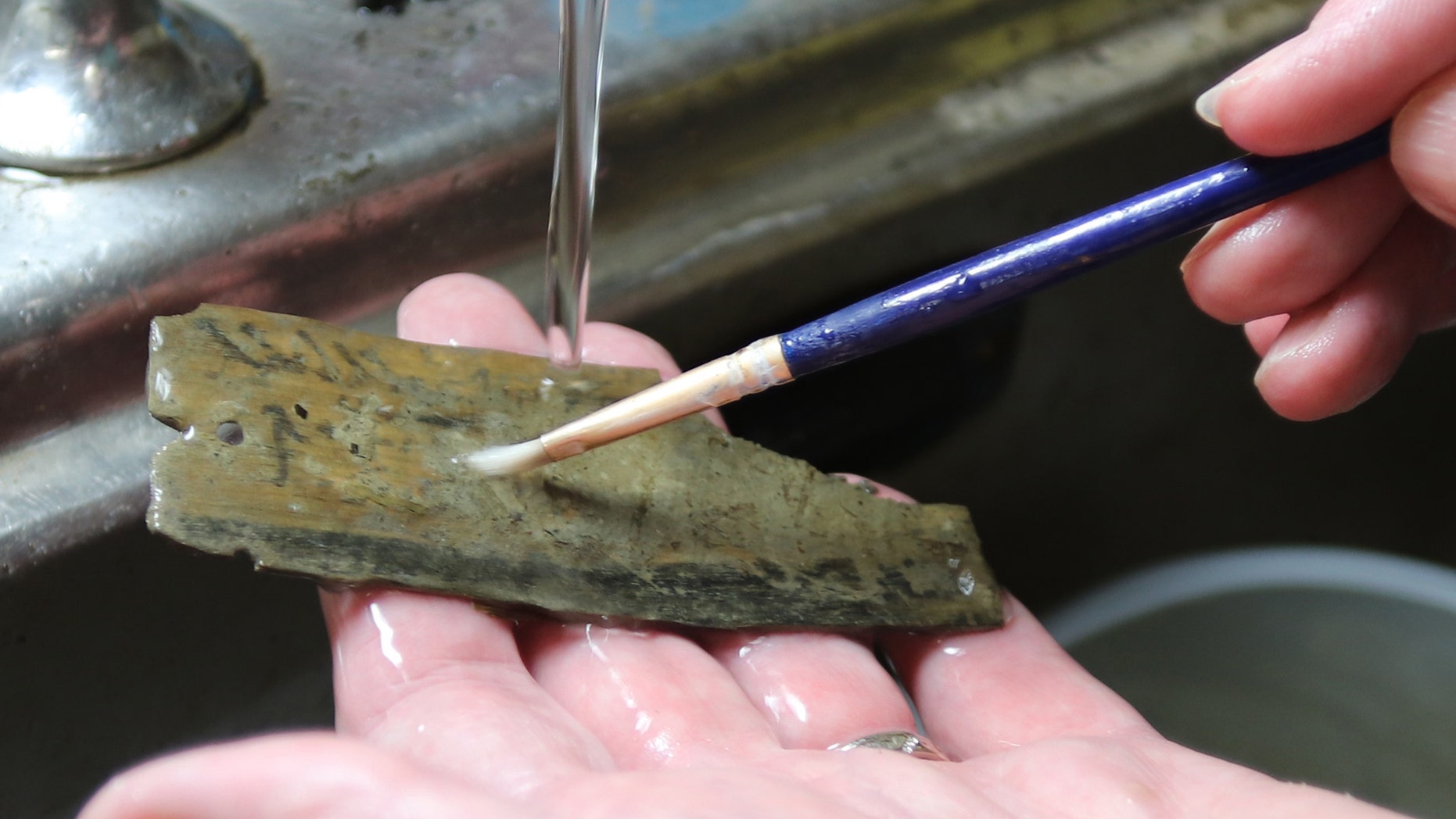 A tablet discovered at Vindolanda being cleaned (The Vindolanda Trust)