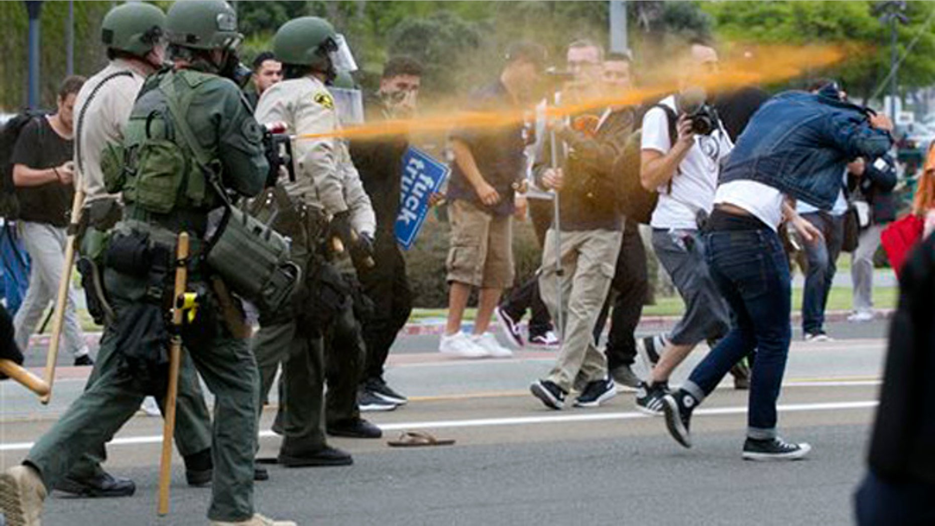 Police pepper sprayed protesters as they moved them down Harbor Drive in San Diego Friday, May 27, 2016. About a thousand Trump protesters demonstrated outside San Diego's convention center as Republican presidential candidate Donald Trump spoke inside to an enthusiastic crowd of supporters packed in tight. Several protesters were arrested. (John Gibbins/The San Diego Union-Tribune via AP) NO SALES; MANDATORY CREDIT