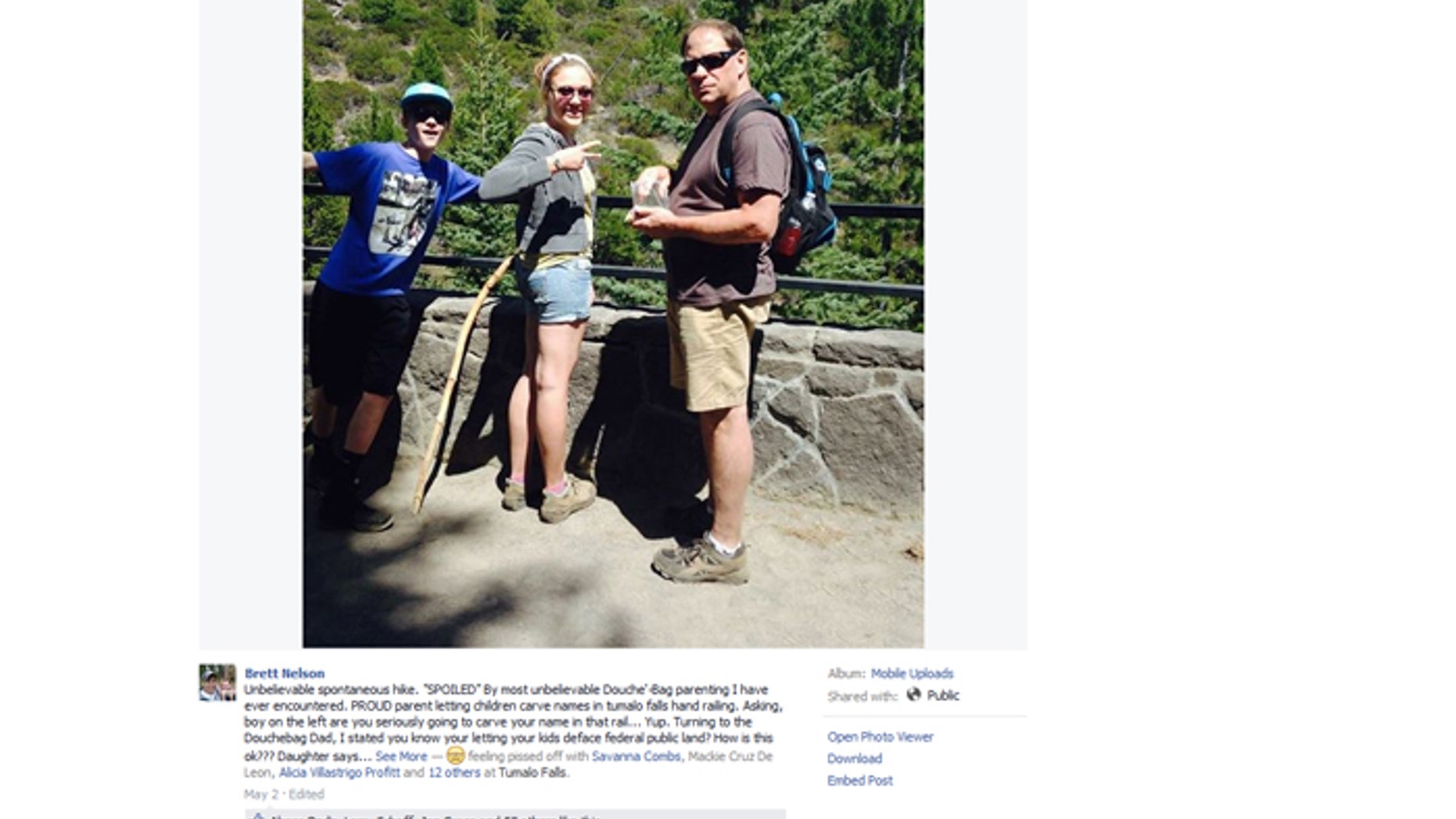 An angry hiker posted this photo online after allegedly seeing the subjects carving initials into a railing.