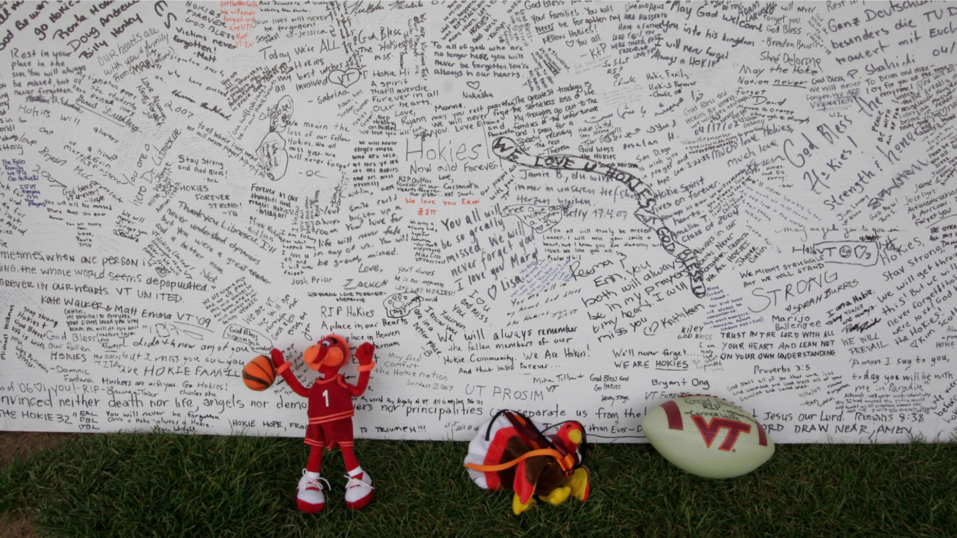 In this April 28, 2007 file photo, a memorial board sits under a tent with items that were placed in front of it, on the Drillfield on the Virginia Tech campus in Blacksburg, Va.